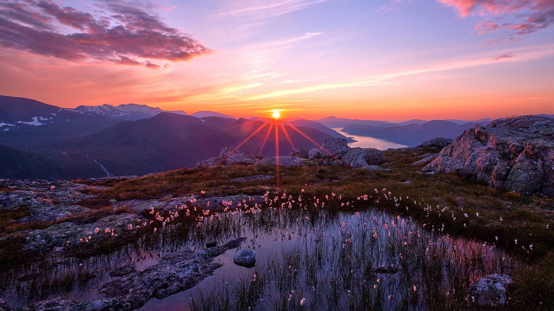Sunset over mountains and a lake with a small pond HD Wallpaper
