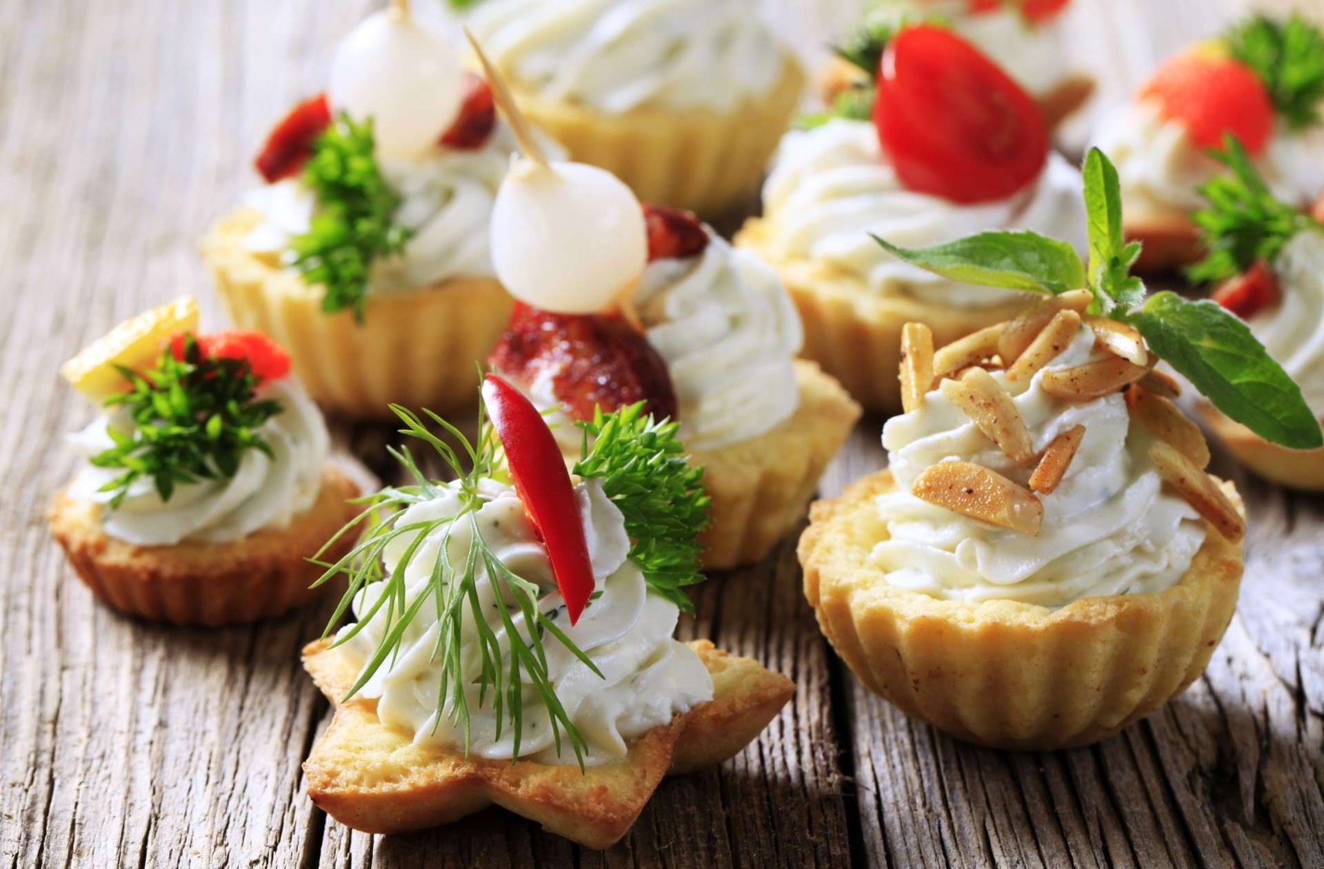 Assortment of mini tarts with cream and garnishes HD Wallpaper