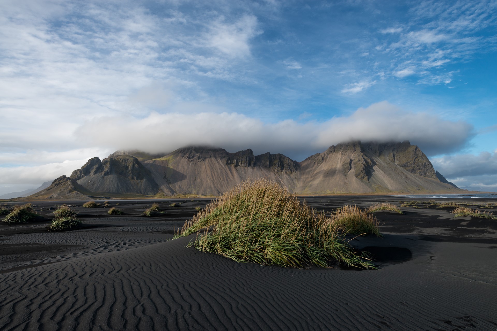Black sand beach with mountains and clouds HD Wallpaper