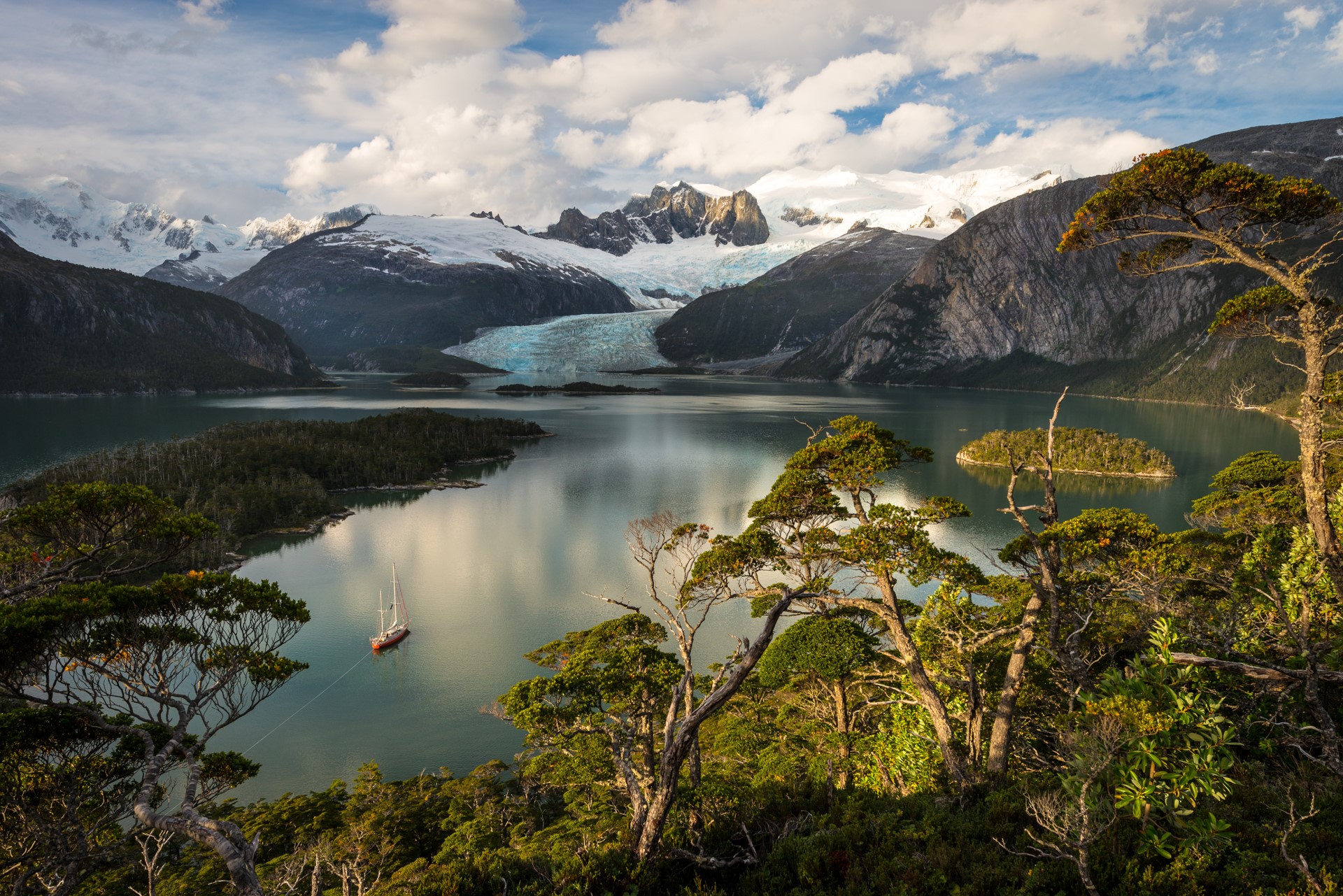 Sailboat on a lake with mountains and glacier HD Wallpaper