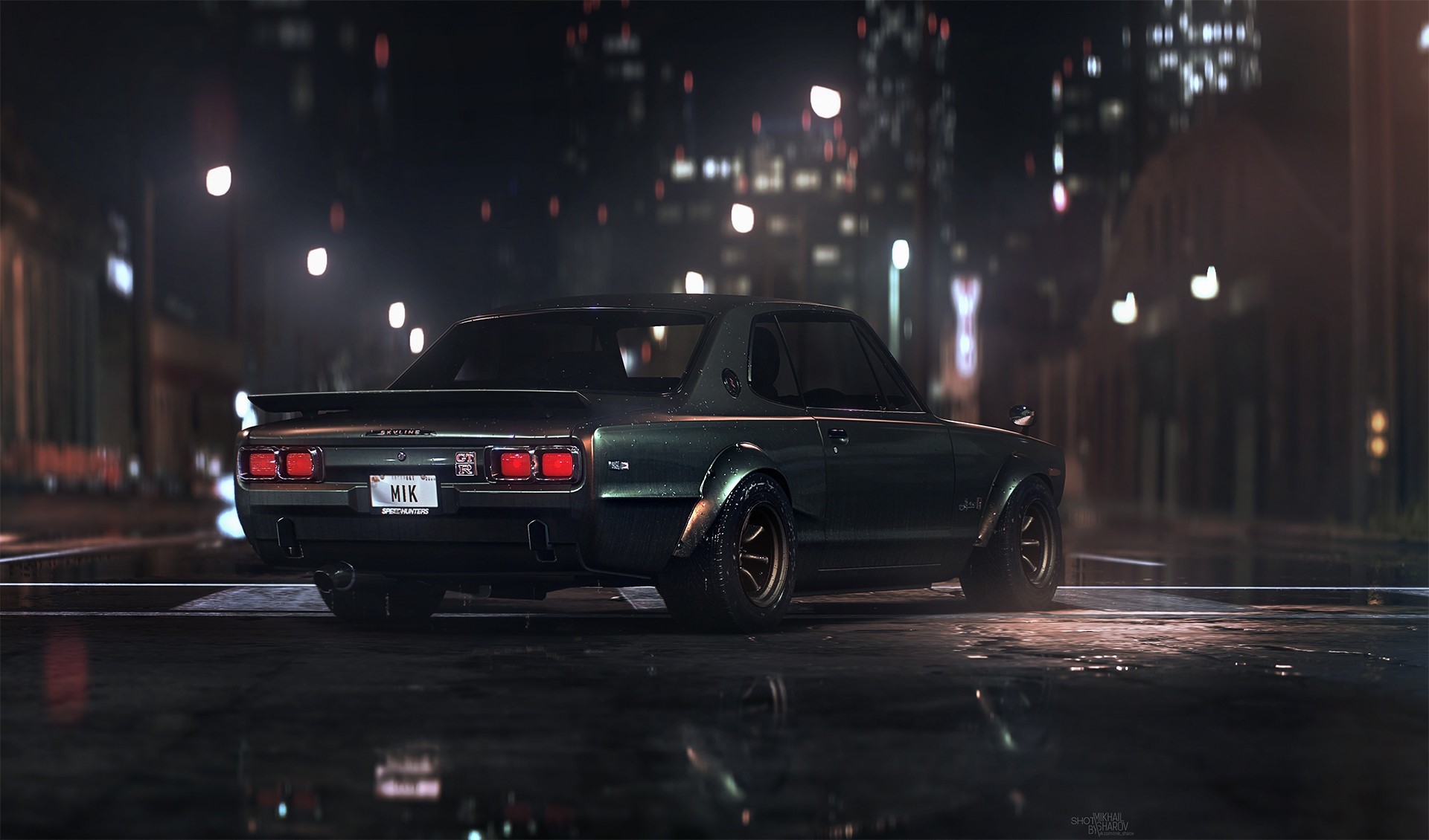 Nissan Skyline GT-R parked on a wet city street at night HD Wallpaper