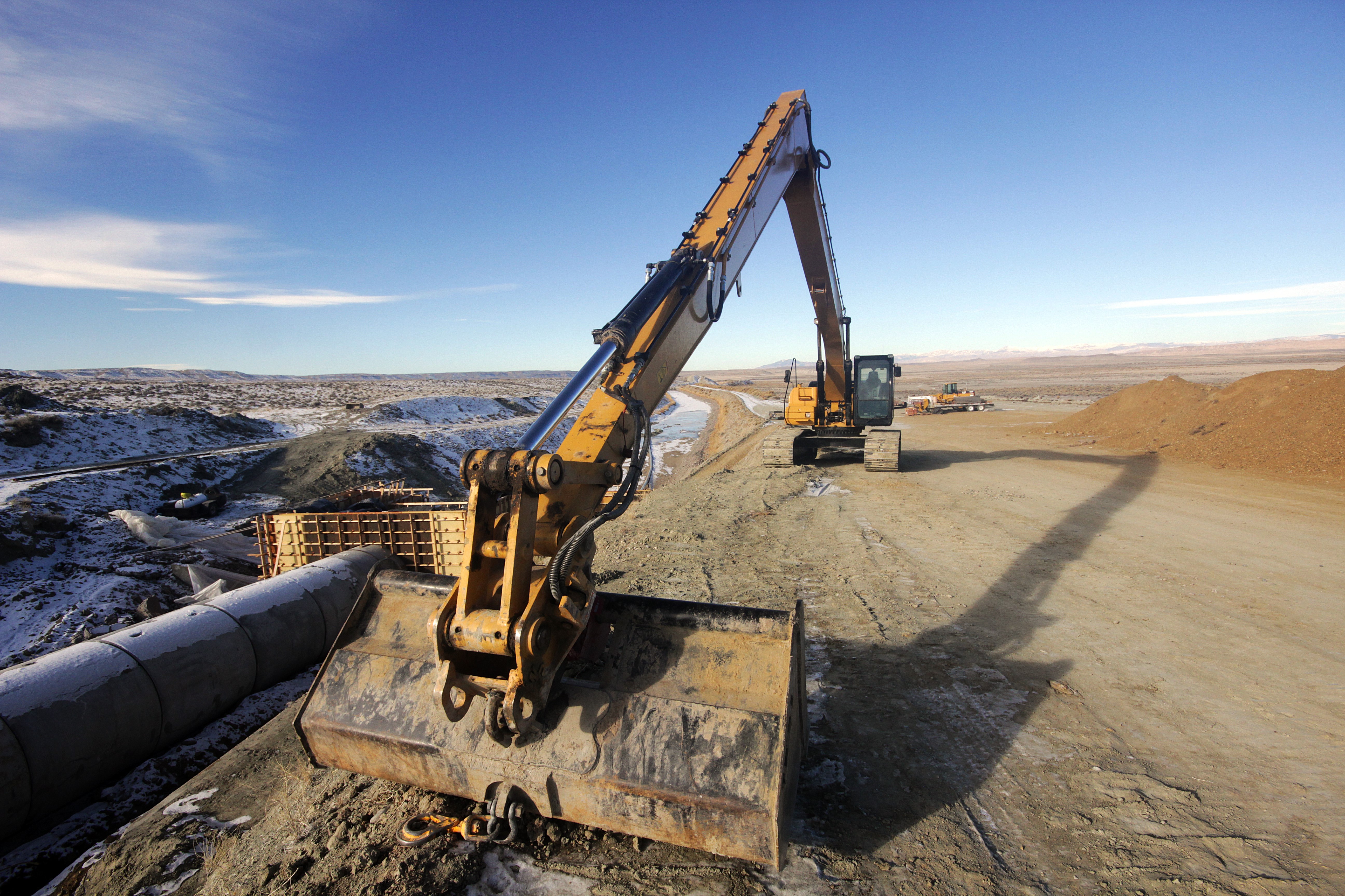 Excavators at a construction site with snow HD Wallpaper