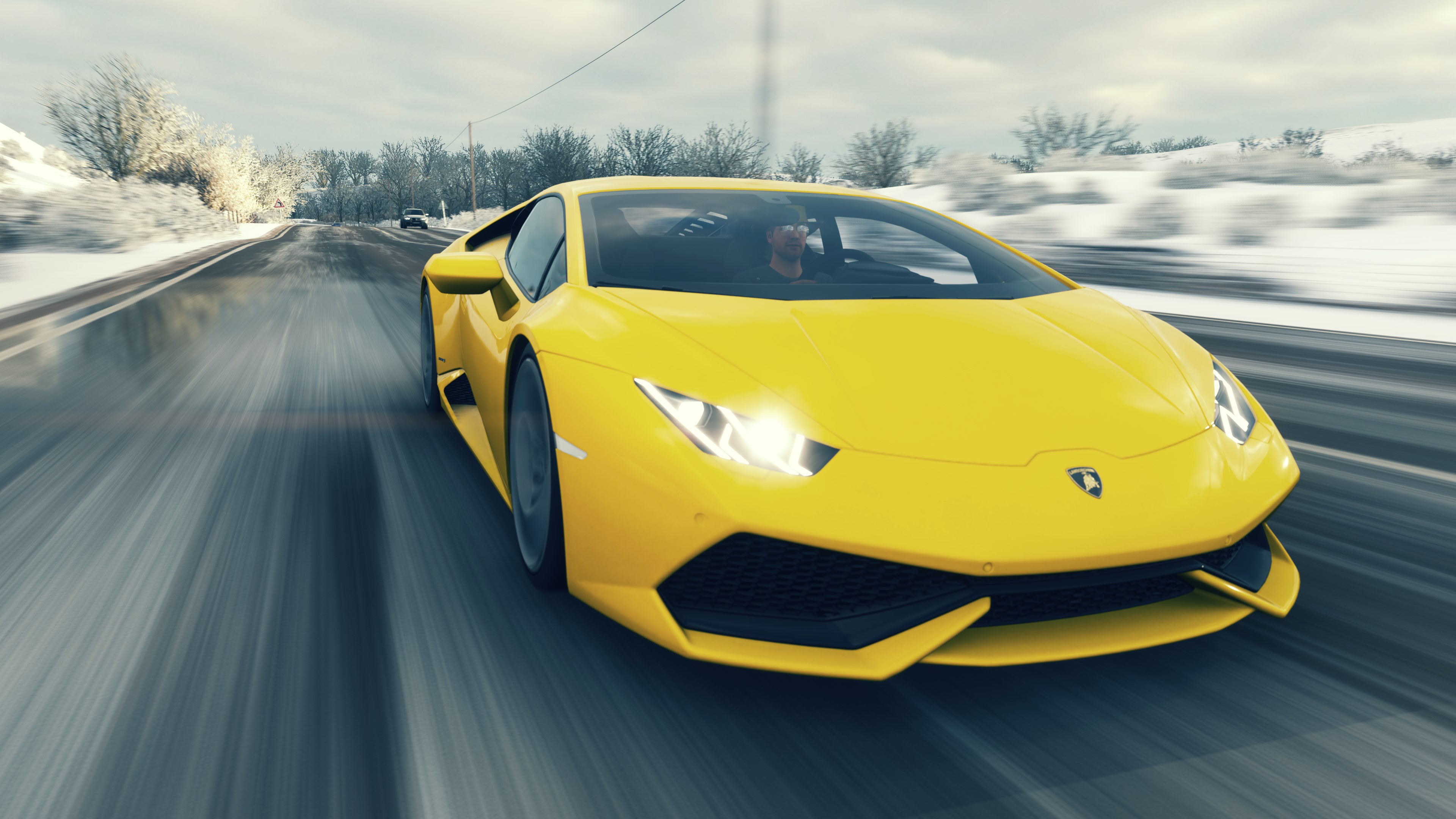 Yellow 2014 Lamborghini Huracán LP 610-4 driving on a snowy road HD Wallpaper