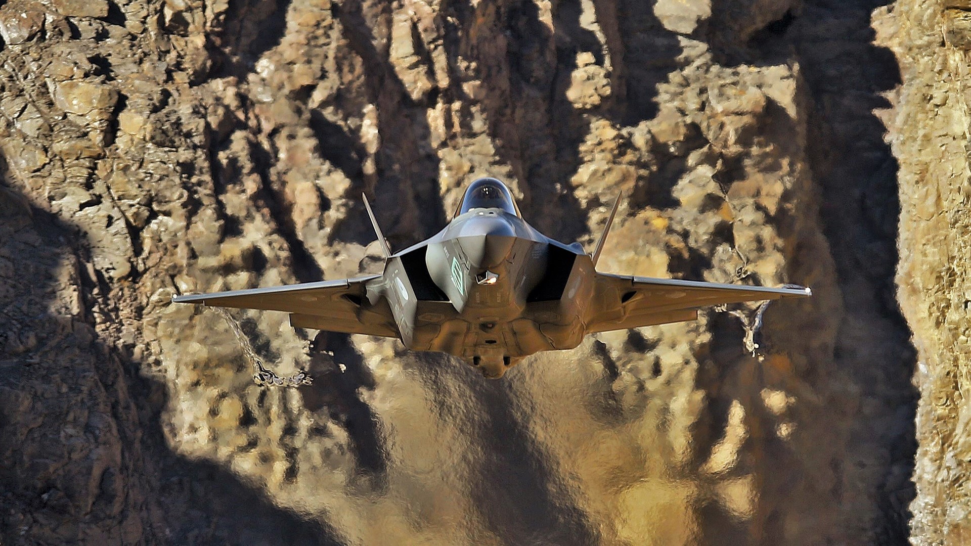 F-35 fighter jet flying through a canyon HD Wallpaper