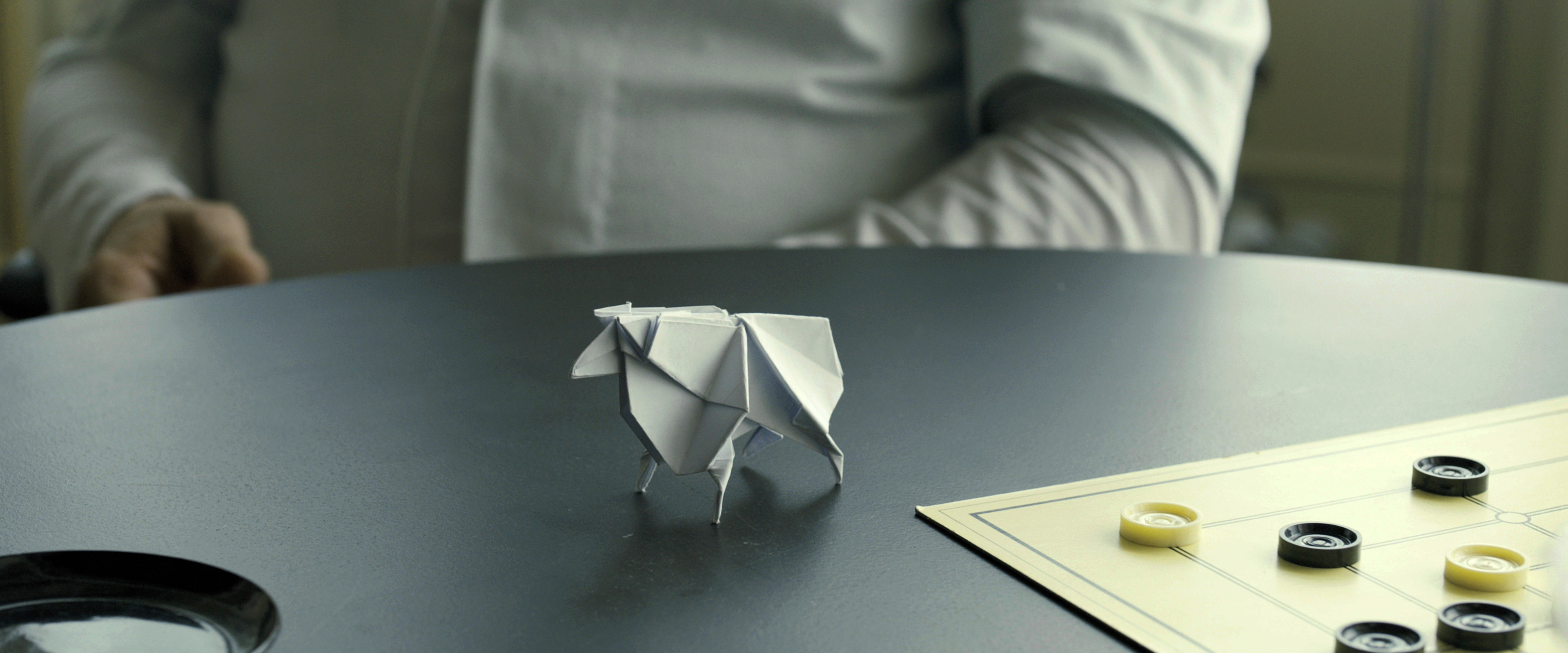 Origami sheep on a table with a board game HD Wallpaper