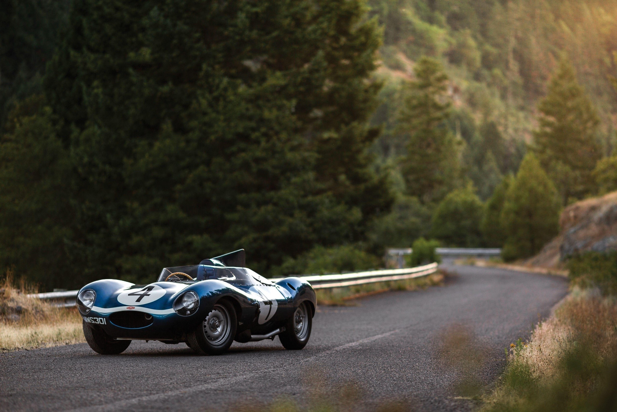 Blue Jaguar D-Type race car on a winding road HD Wallpaper
