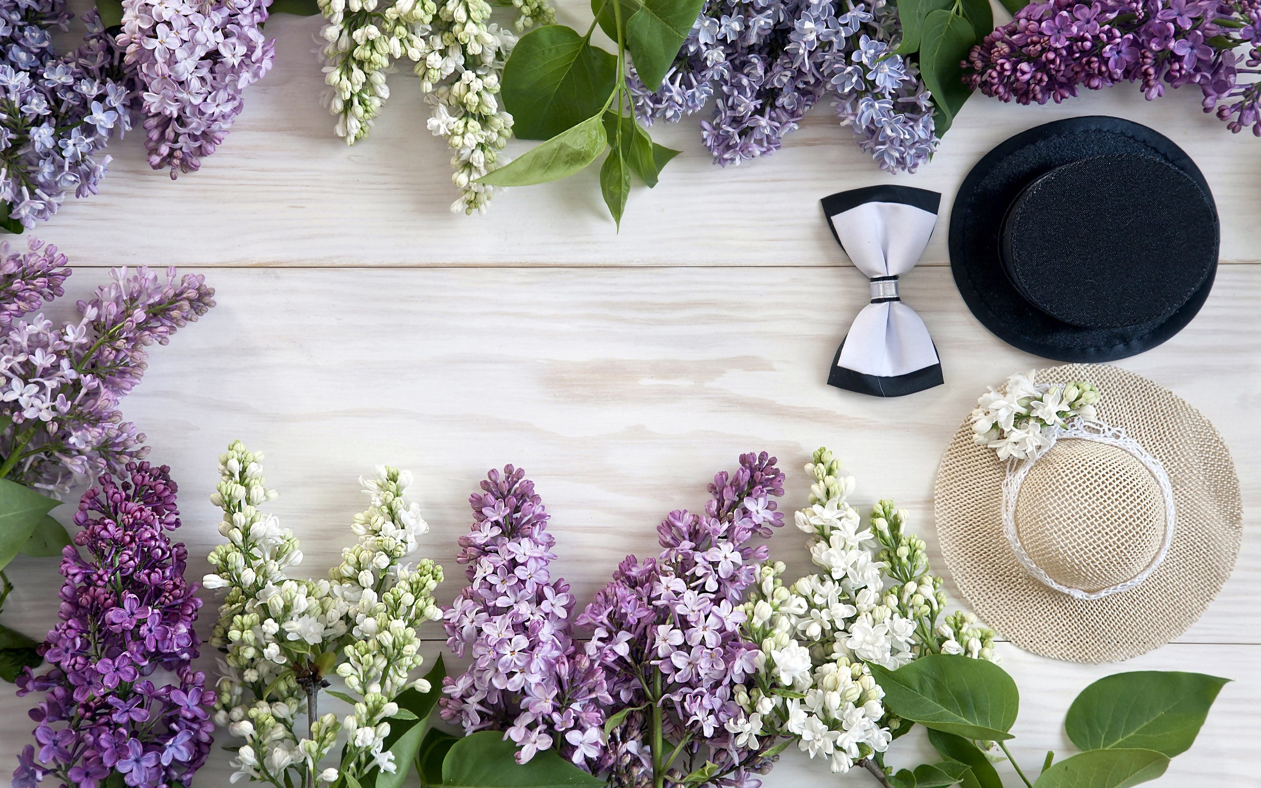 Lilacs and hats on a wooden table HD Wallpaper