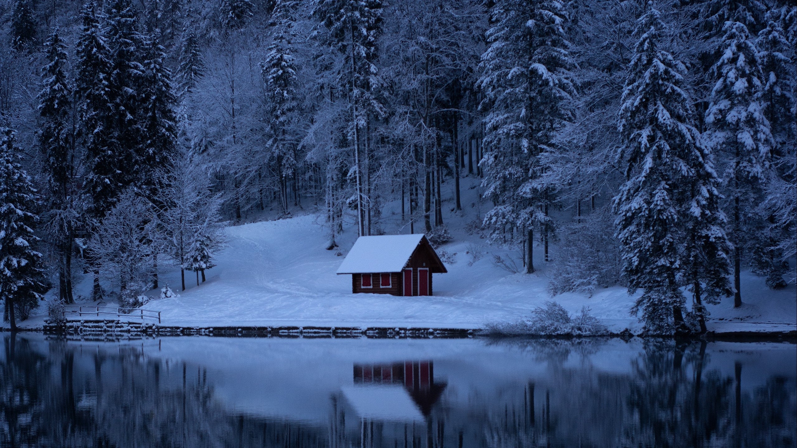 Red cabin by a snowy lake in a winter forest HD Wallpaper