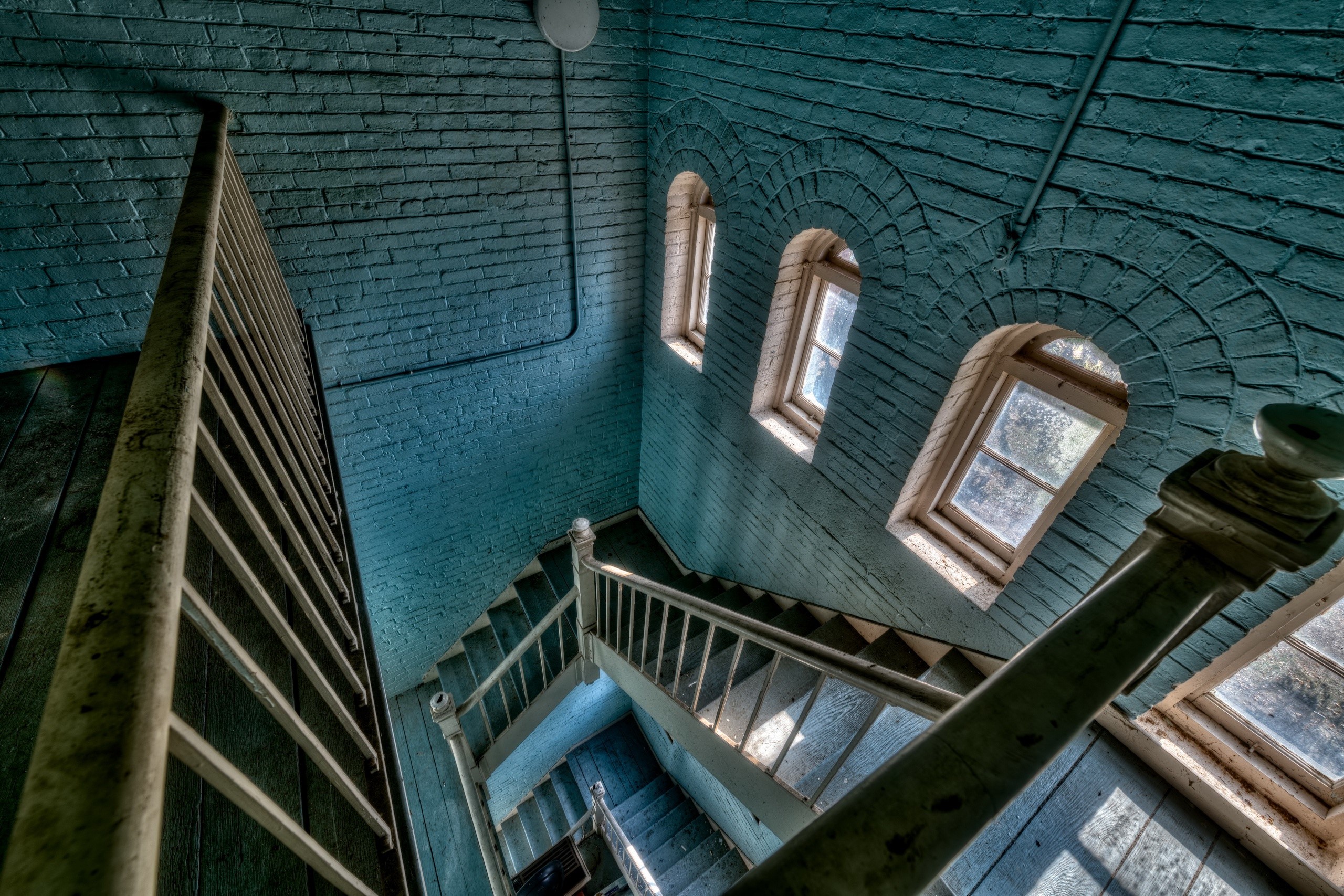 Interior of a building with a spiral staircase and windows HD Wallpaper