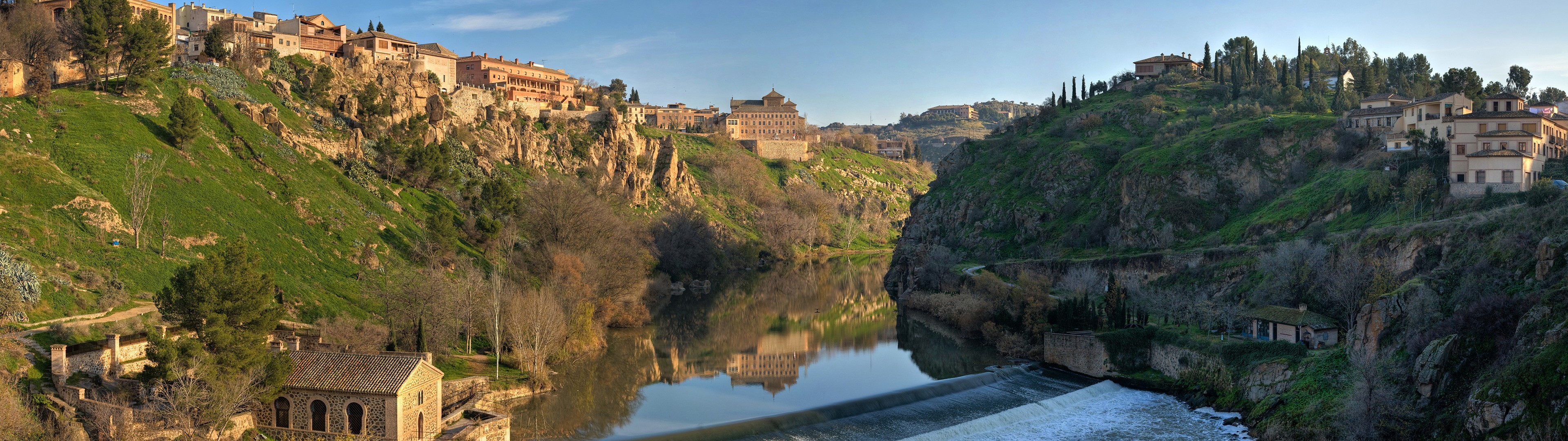 River valley with historic buildings on hills HD Wallpaper