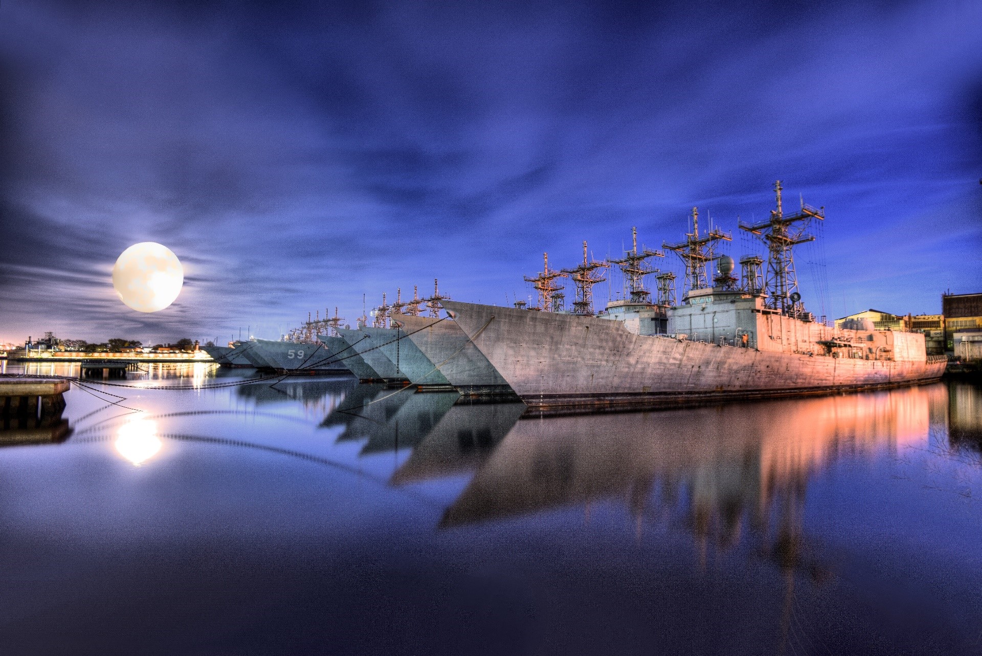 US Navy ships docked at night under the moon HD Wallpaper