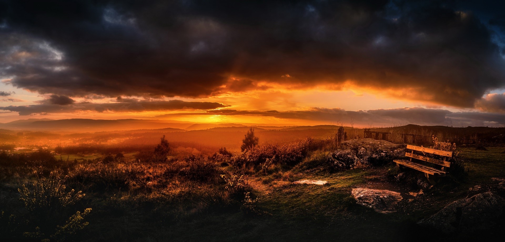 Sunset over rolling hills with a wooden bench HD Wallpaper