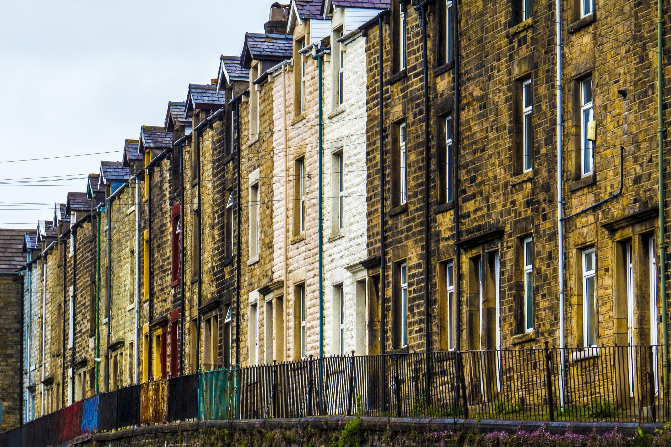 Row of terraced houses with colorful fences HD Wallpaper