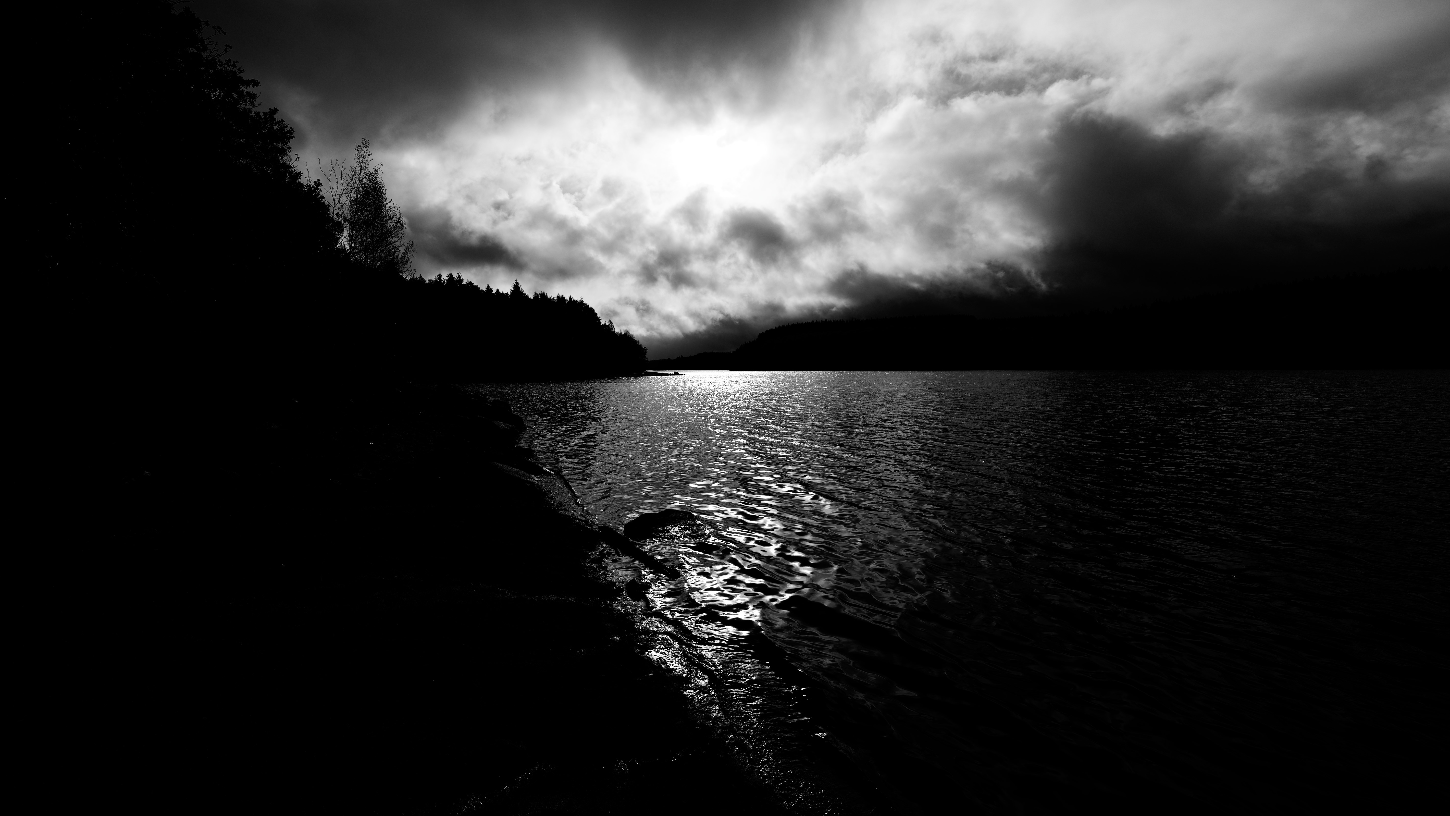 Monochrome lake landscape with dramatic clouds and sunlight HD Wallpaper
