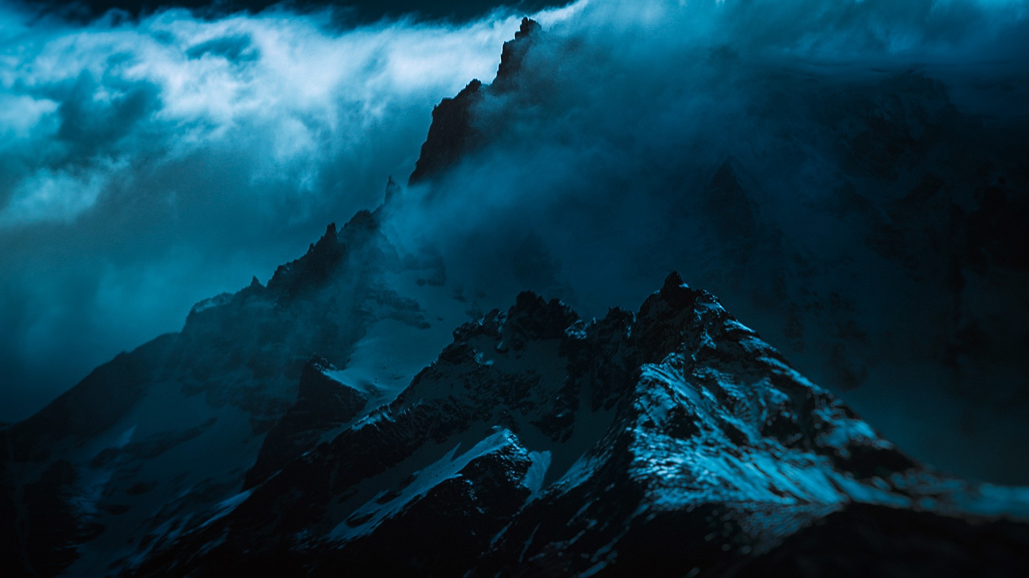 Dark, misty, snowy mountain peaks HD Wallpaper