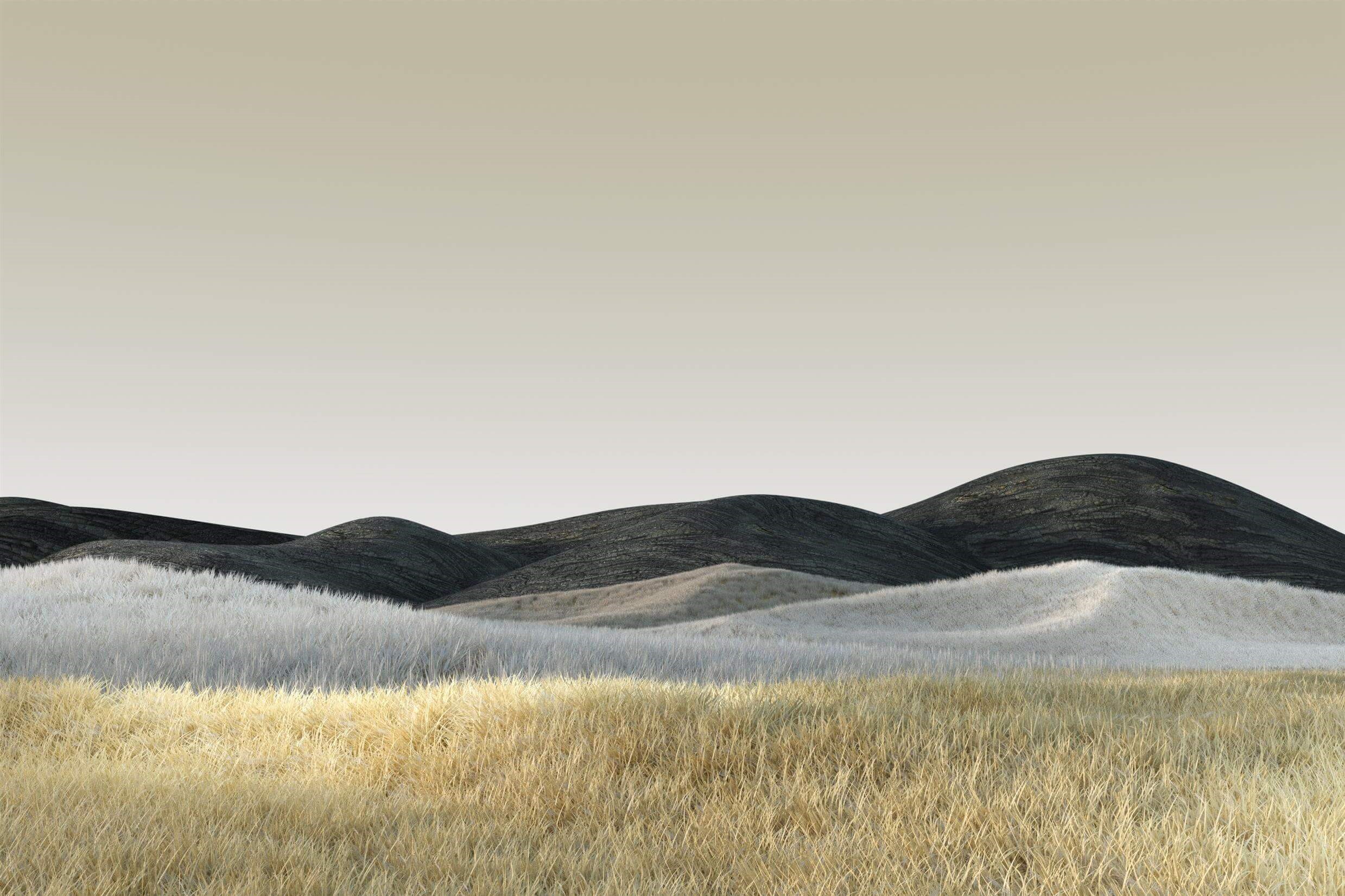Rolling hills with dry grass and dark peaks HD Wallpaper