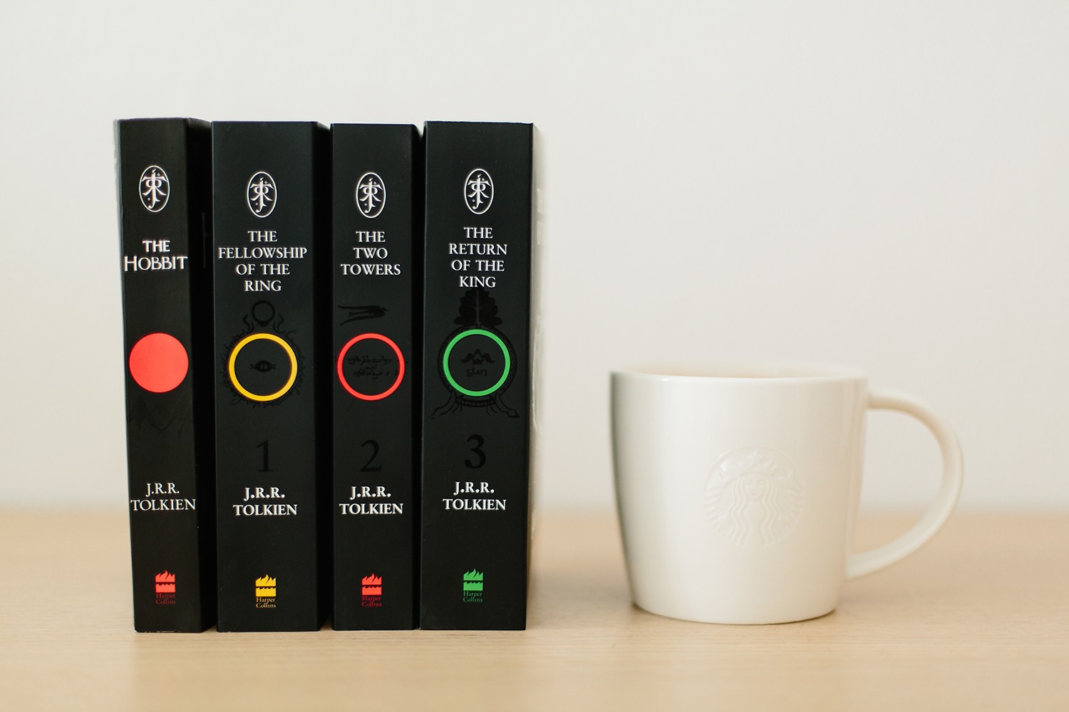 The Hobbit and The Lord of the Rings books with a mug HD Wallpaper