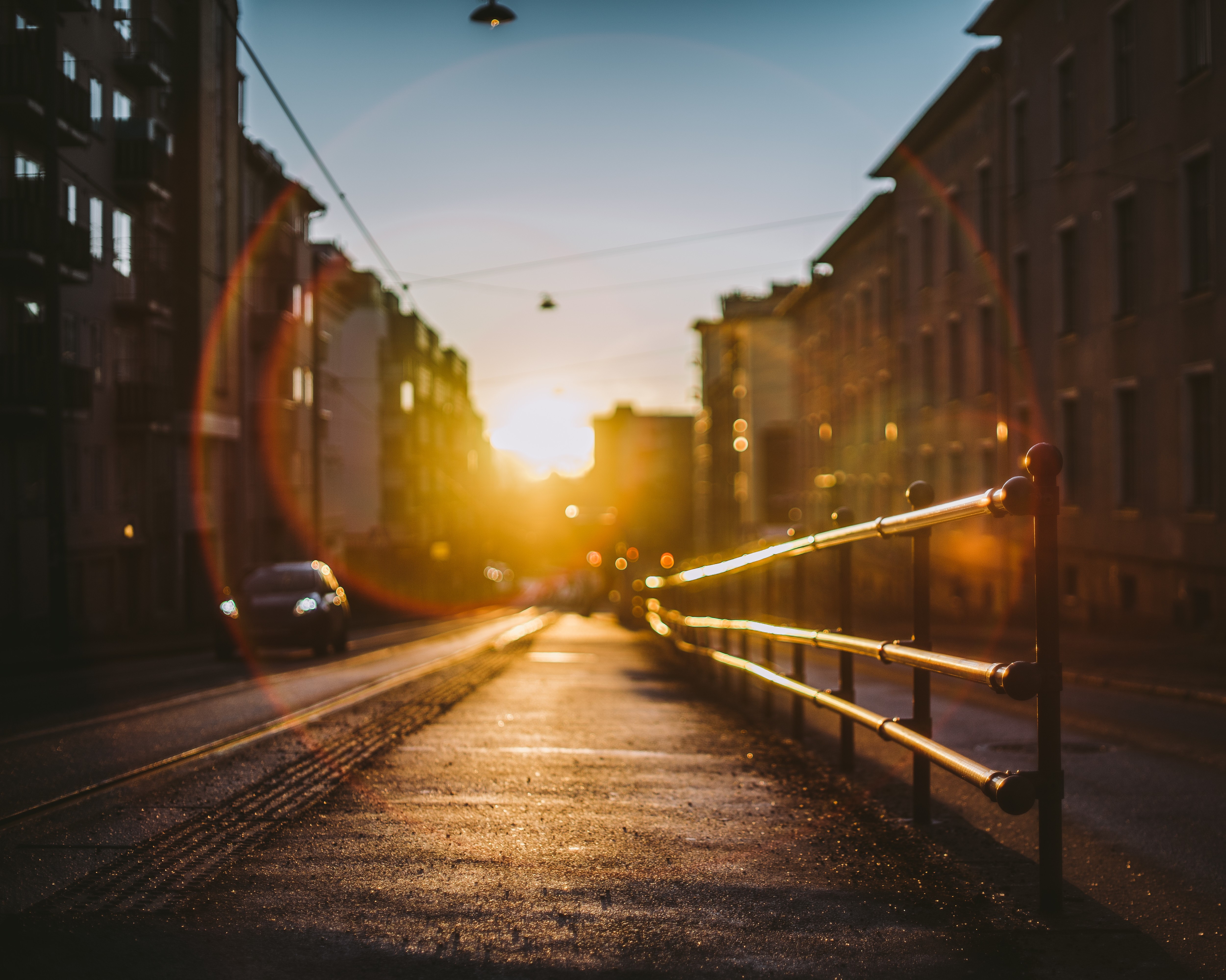Sunset over city street with railing HD Wallpaper