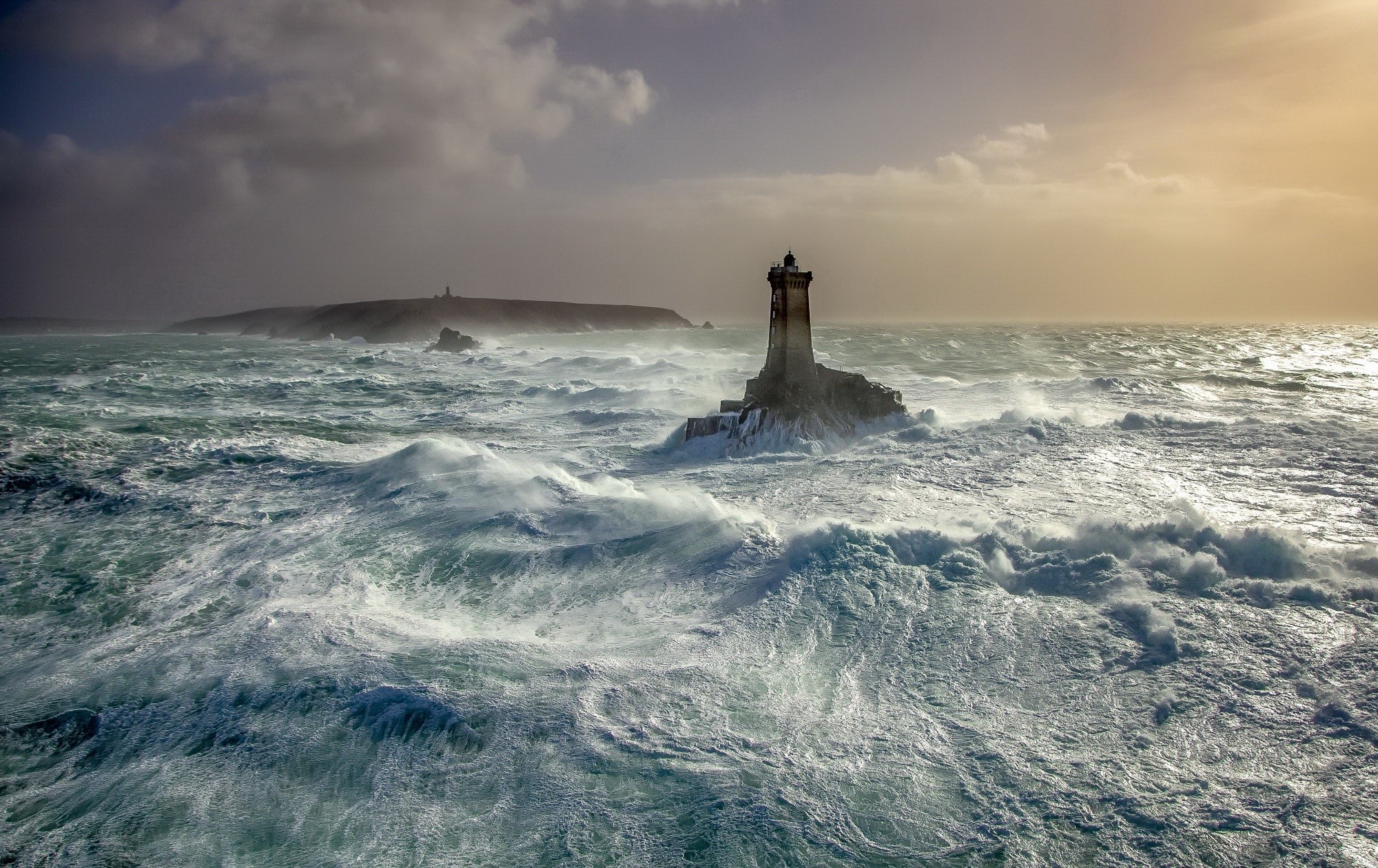 Lighthouse in rough seas with stormy skies HD Wallpaper