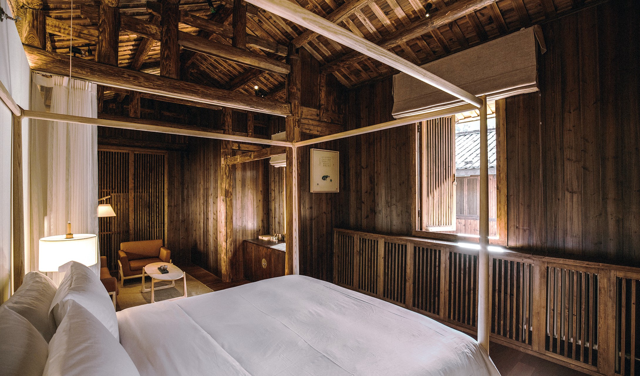 Rustic wooden bedroom with canopy bed and sitting area HD Wallpaper