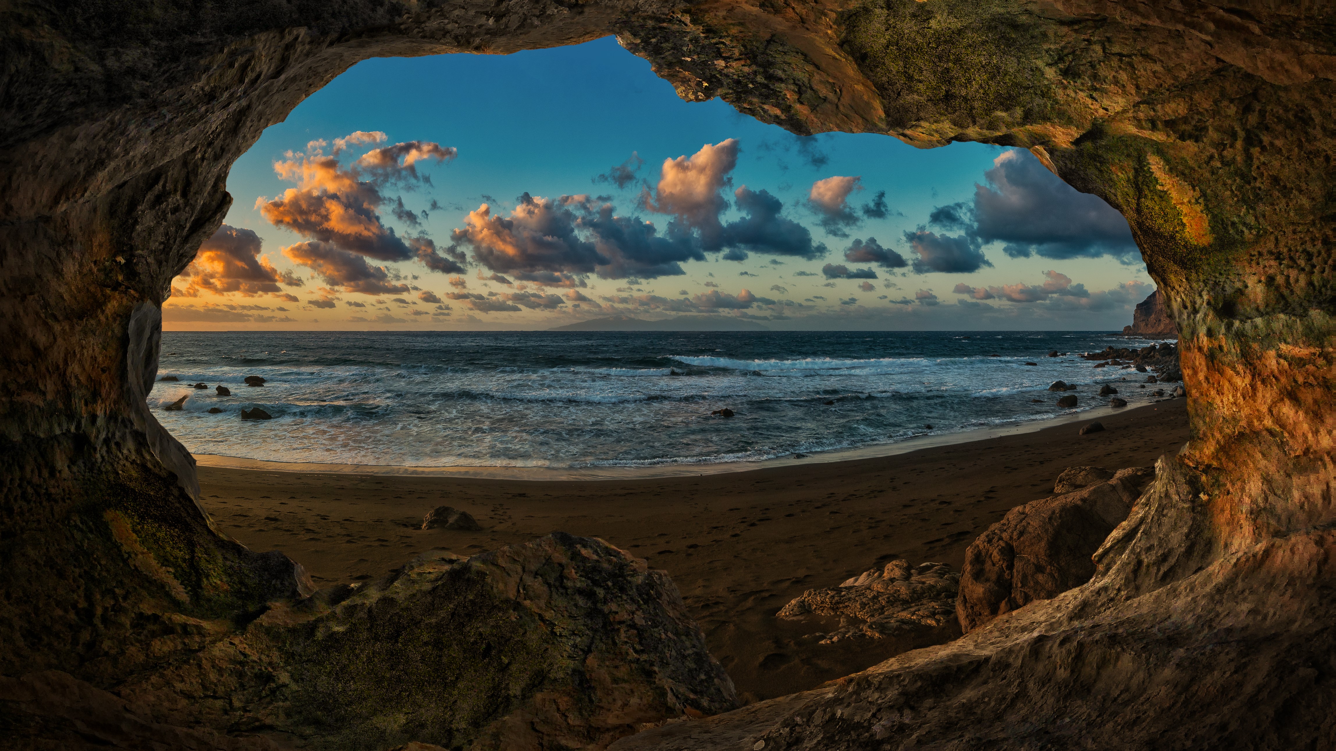 Cave view of Canary Islands coast at sunset HD Wallpaper