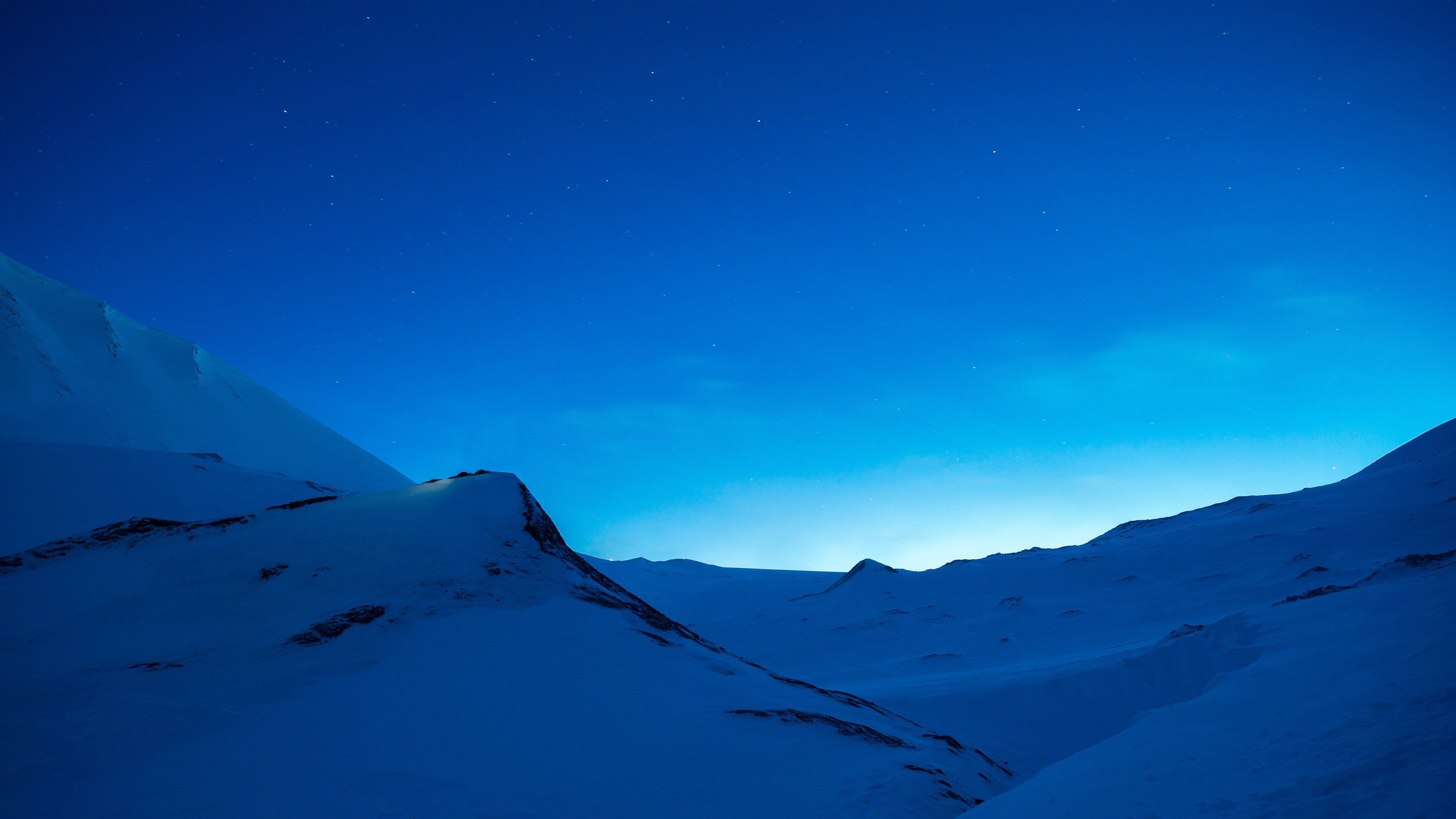 Snowy hills under a clear blue night sky HD Wallpaper