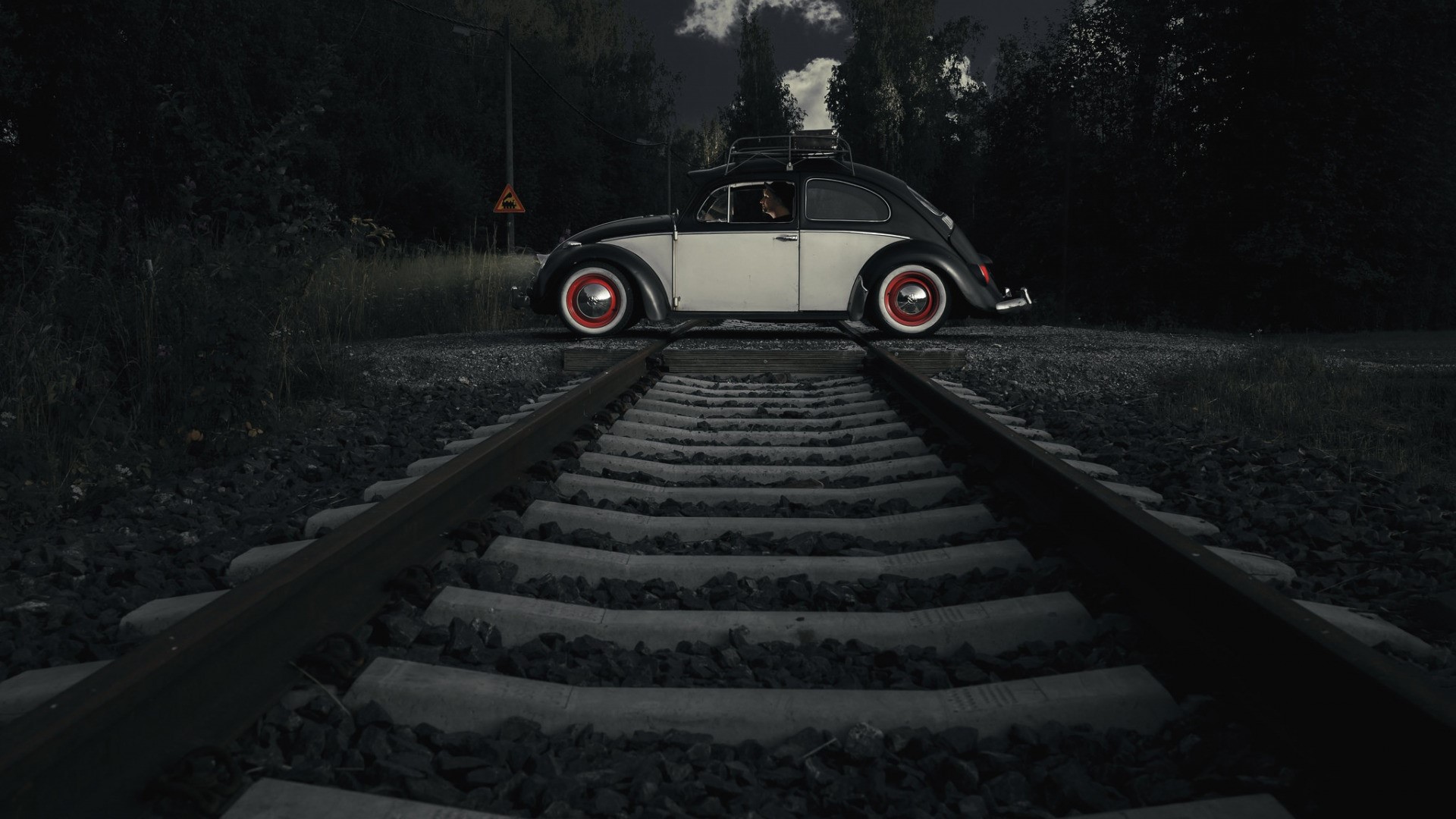 Volkswagen Beetle on railway tracks at dusk HD Wallpaper