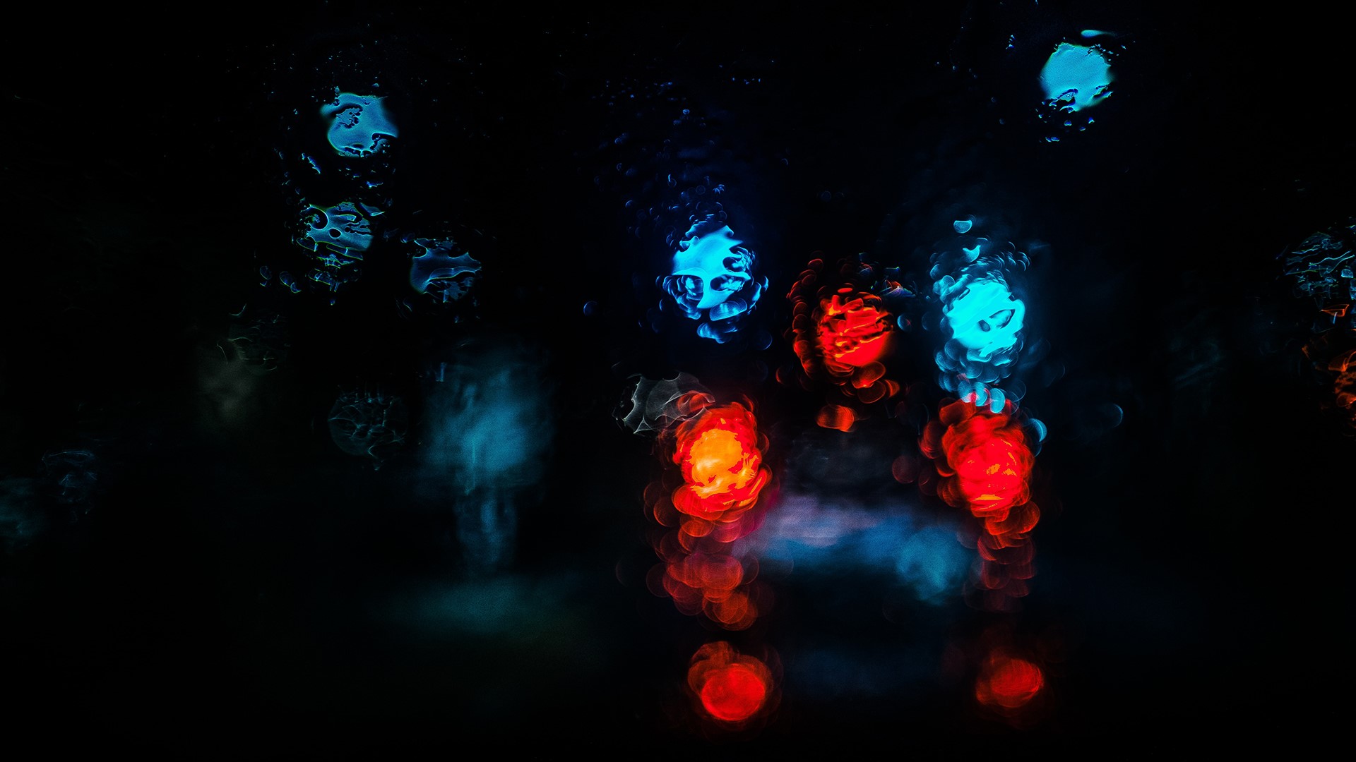 Blurred colorful lights on wet glass at night HD Wallpaper