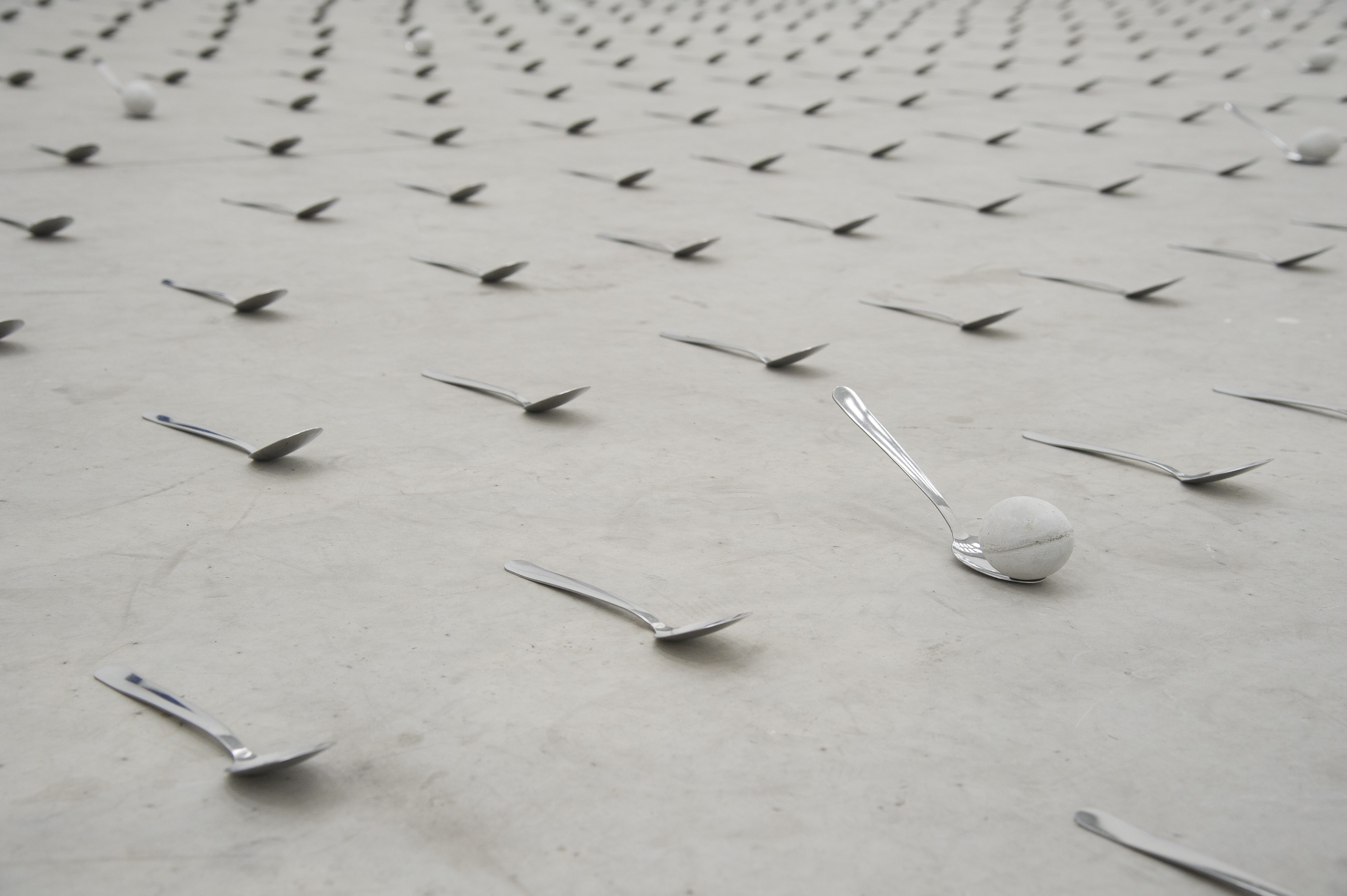 Spoons and a ball on a concrete floor HD Wallpaper