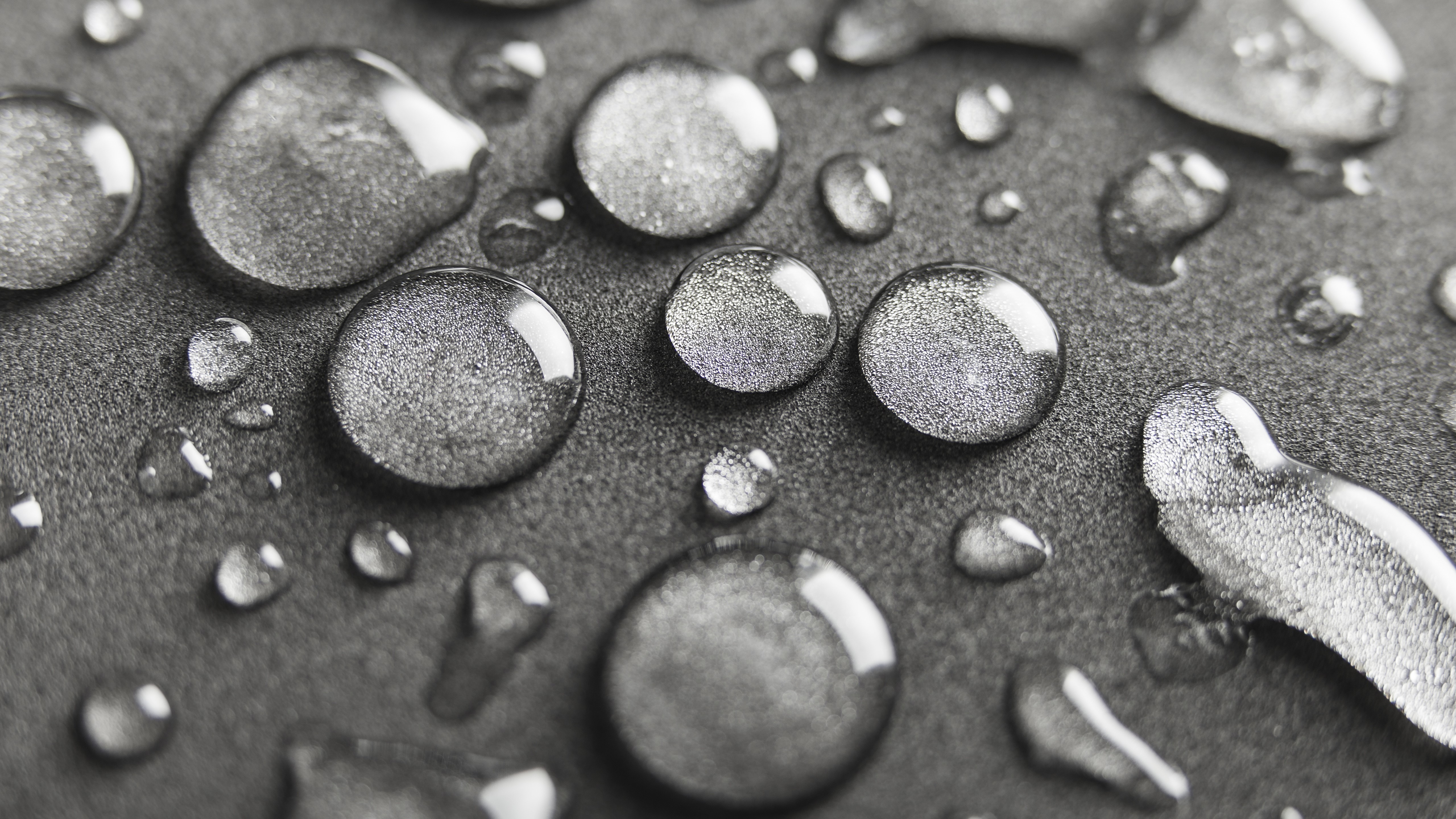 Macro view of water drops on gray surface HD Wallpaper