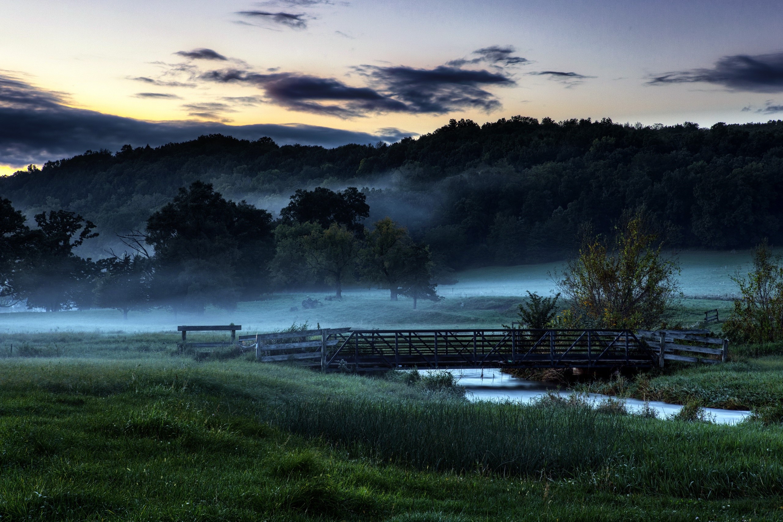 Bridge over a stream in misty morning landscape HD Wallpaper