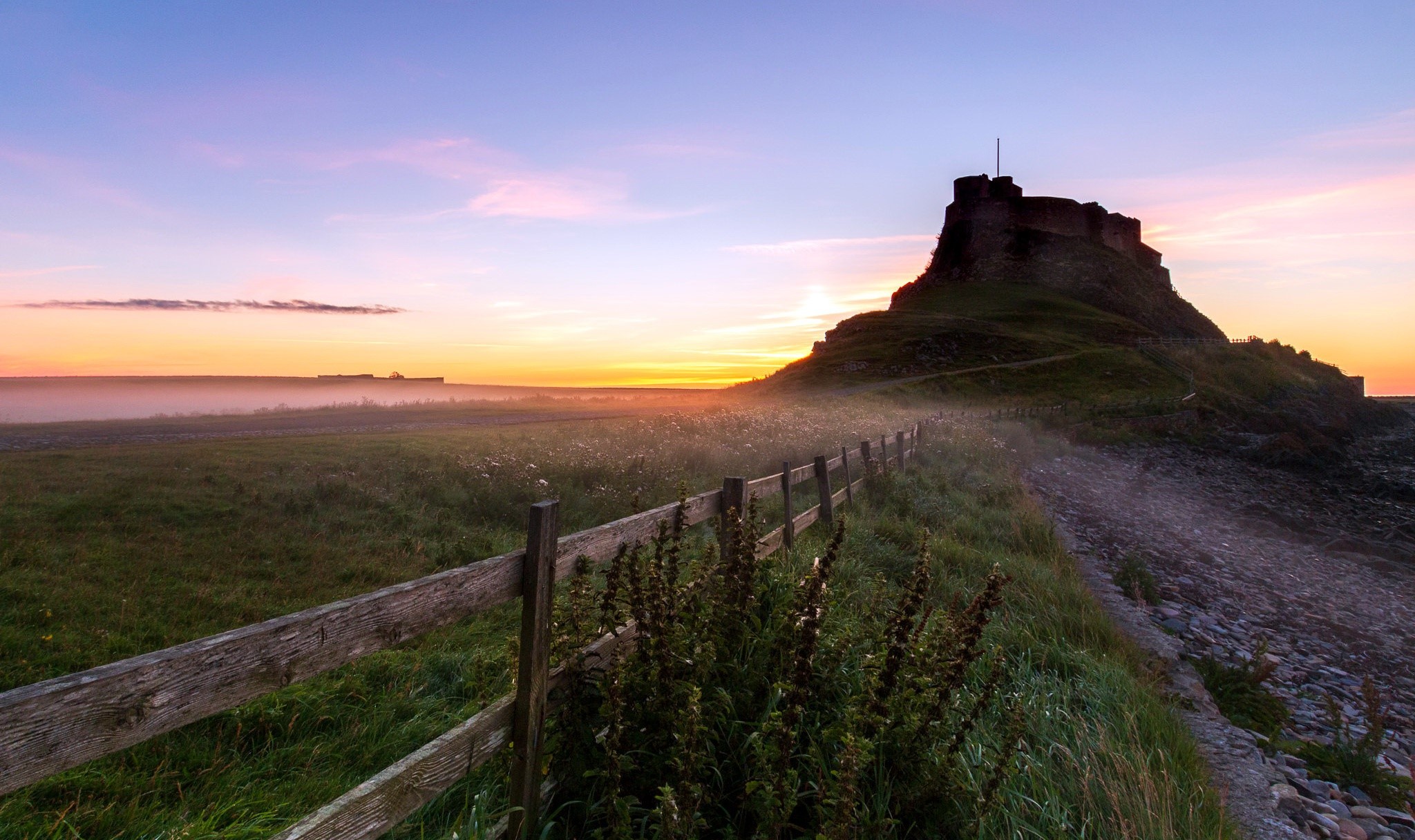 Castle on a hill at sunrise with a fence HD Wallpaper