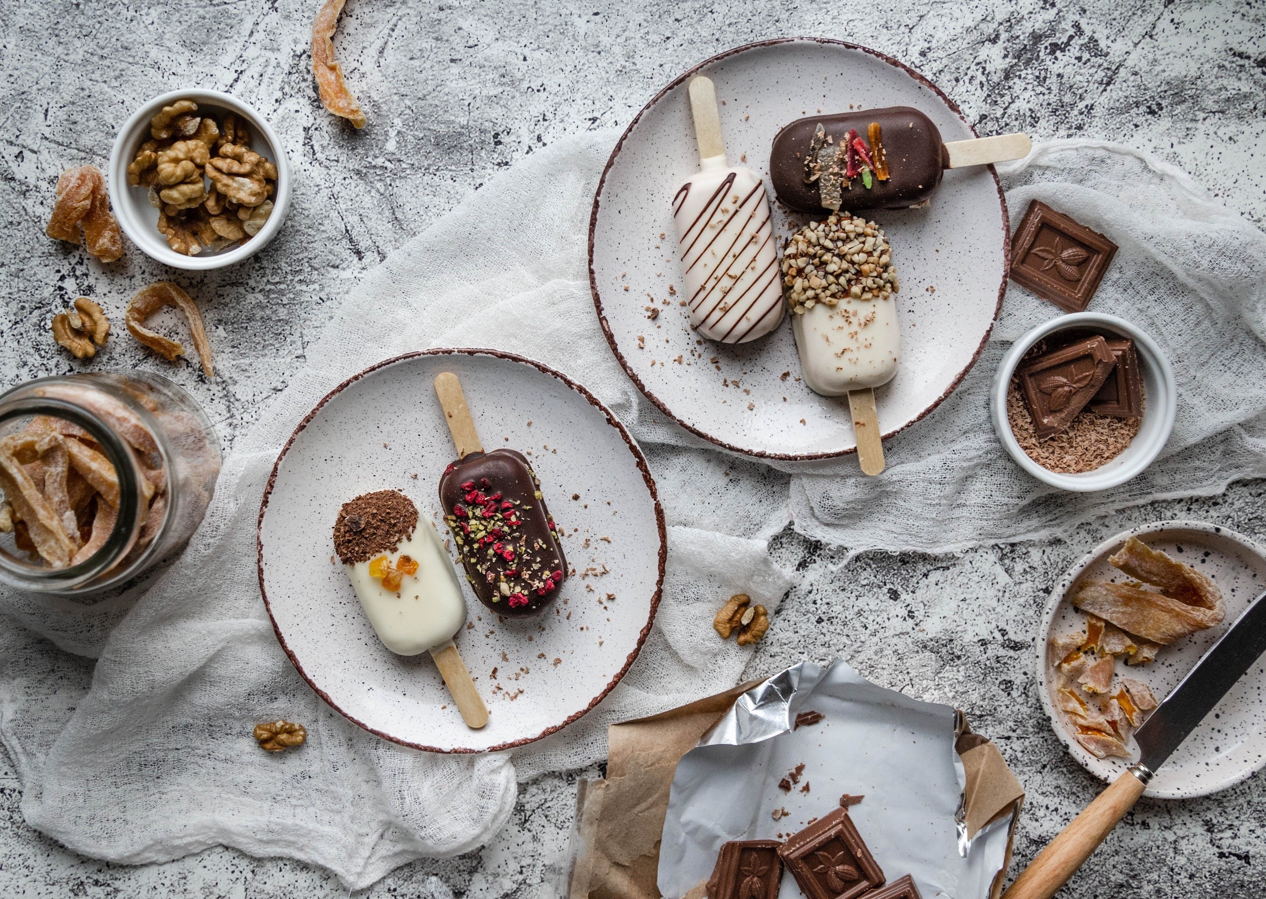 Chocolate-covered popsicles with nuts and dried fruit HD Wallpaper