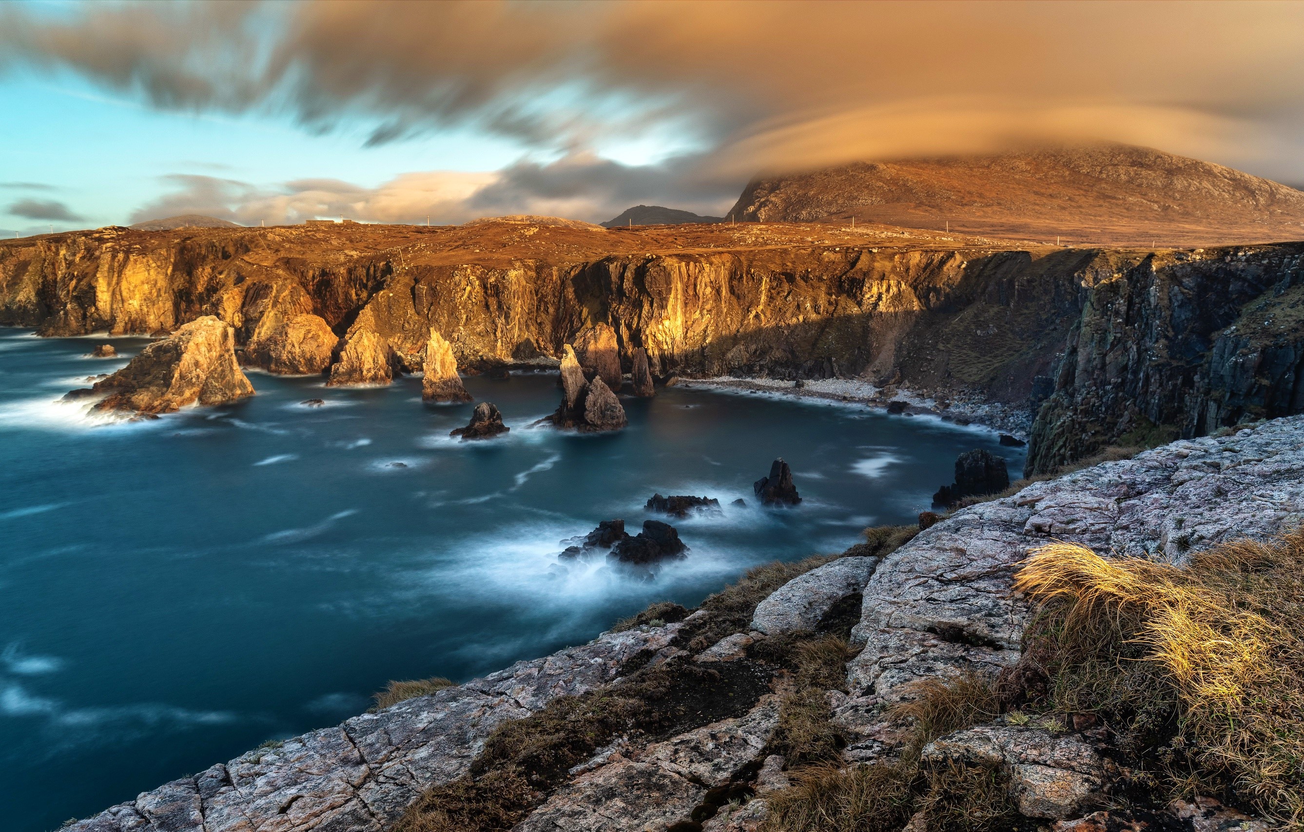 Dramatic coastal cliffs and sea stacks at sunset HD Wallpaper