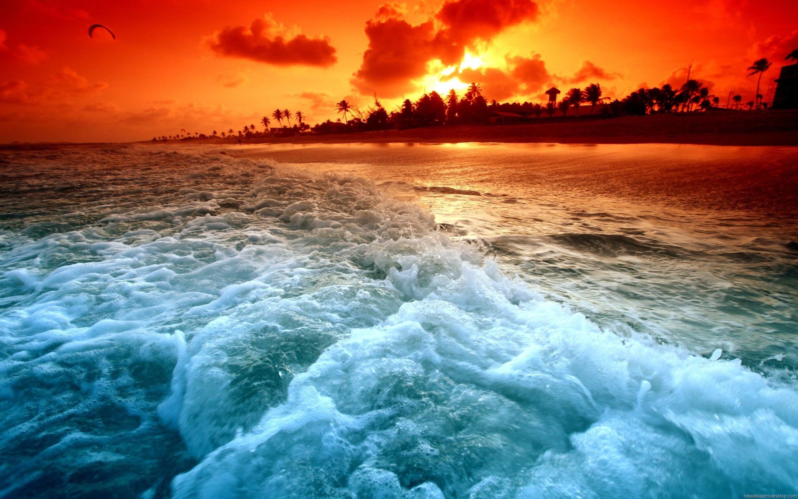 Sunset over a tropical beach with crashing waves HD Wallpaper