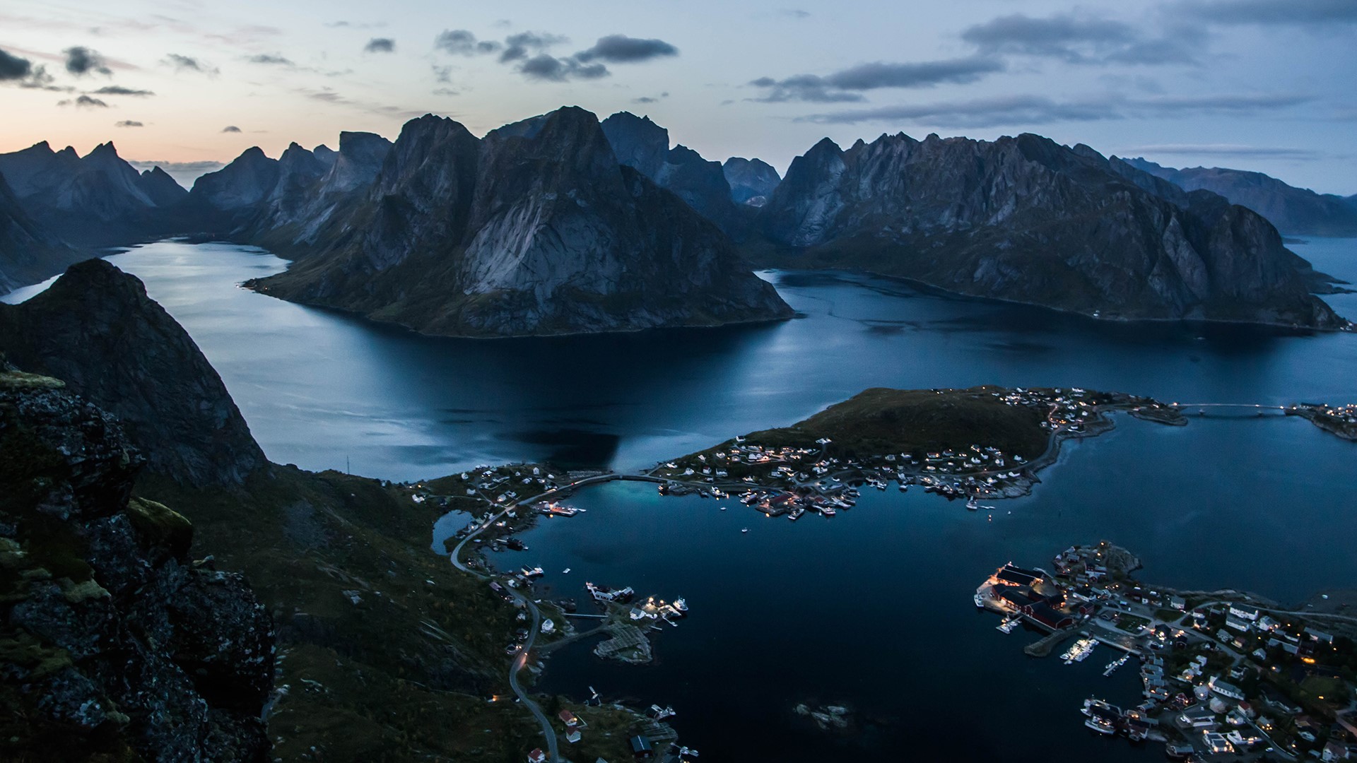 Village nestled in a Norwegian fjord with mountains HD Wallpaper