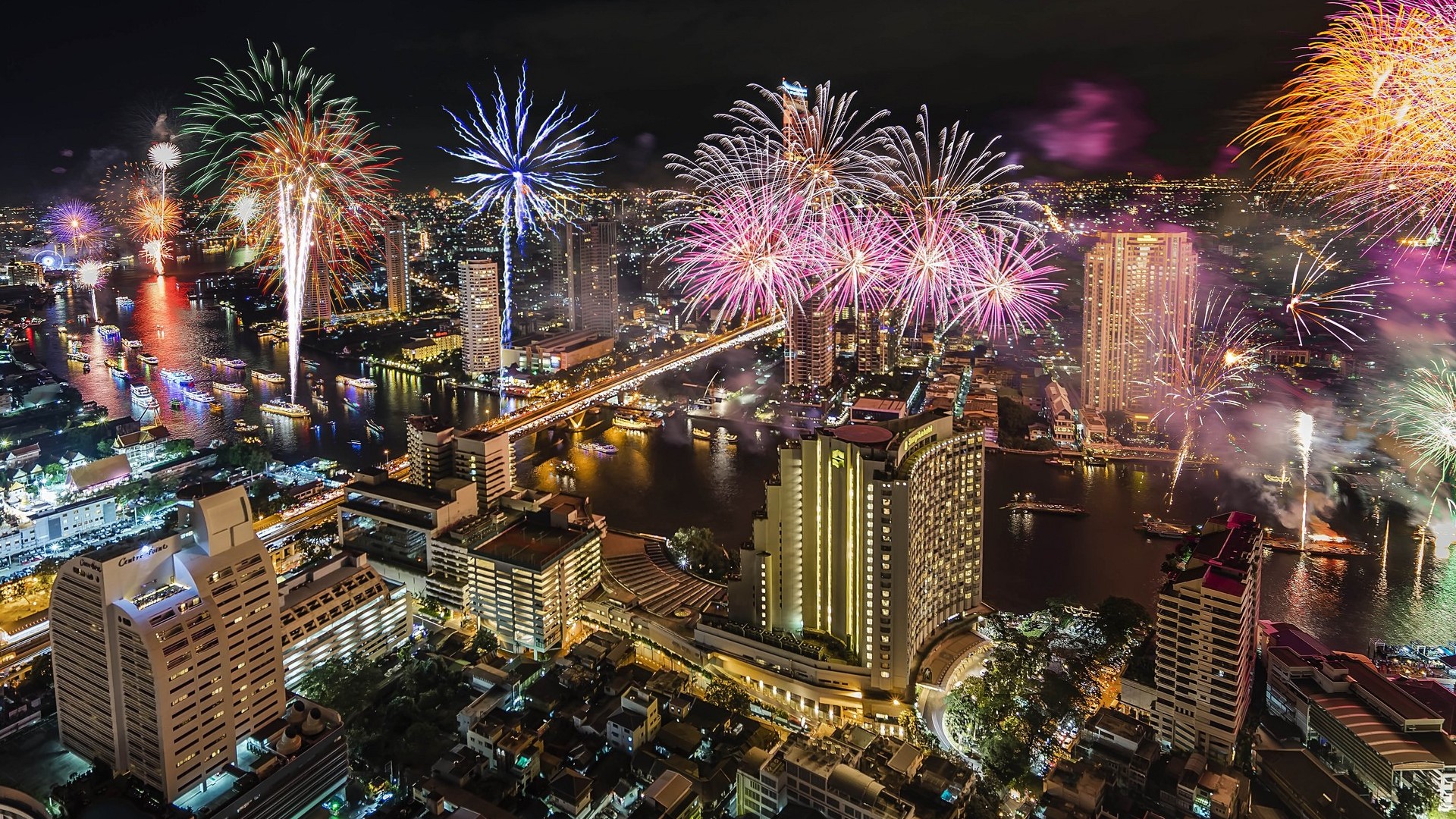 Bangkok skyline with fireworks over the Chao Phraya River HD Wallpaper