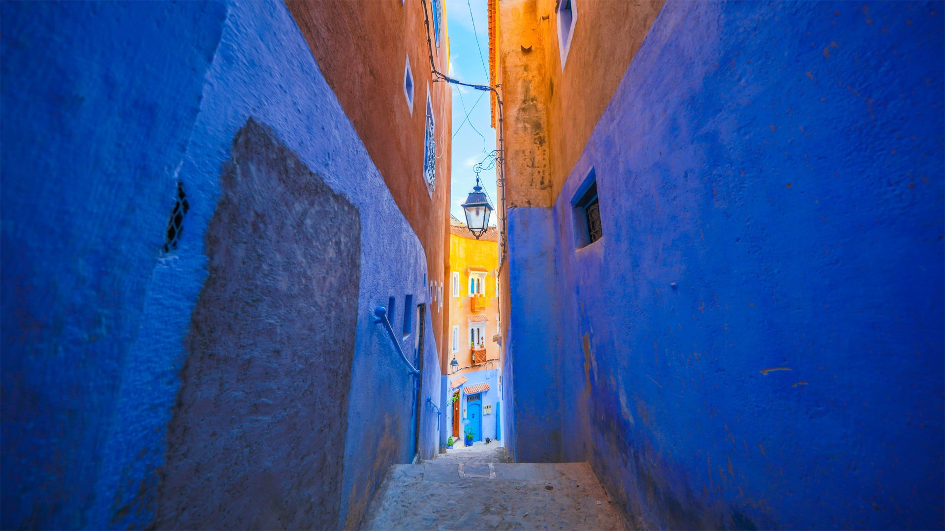 Blue alleyway in Morocco with orange buildings HD Wallpaper