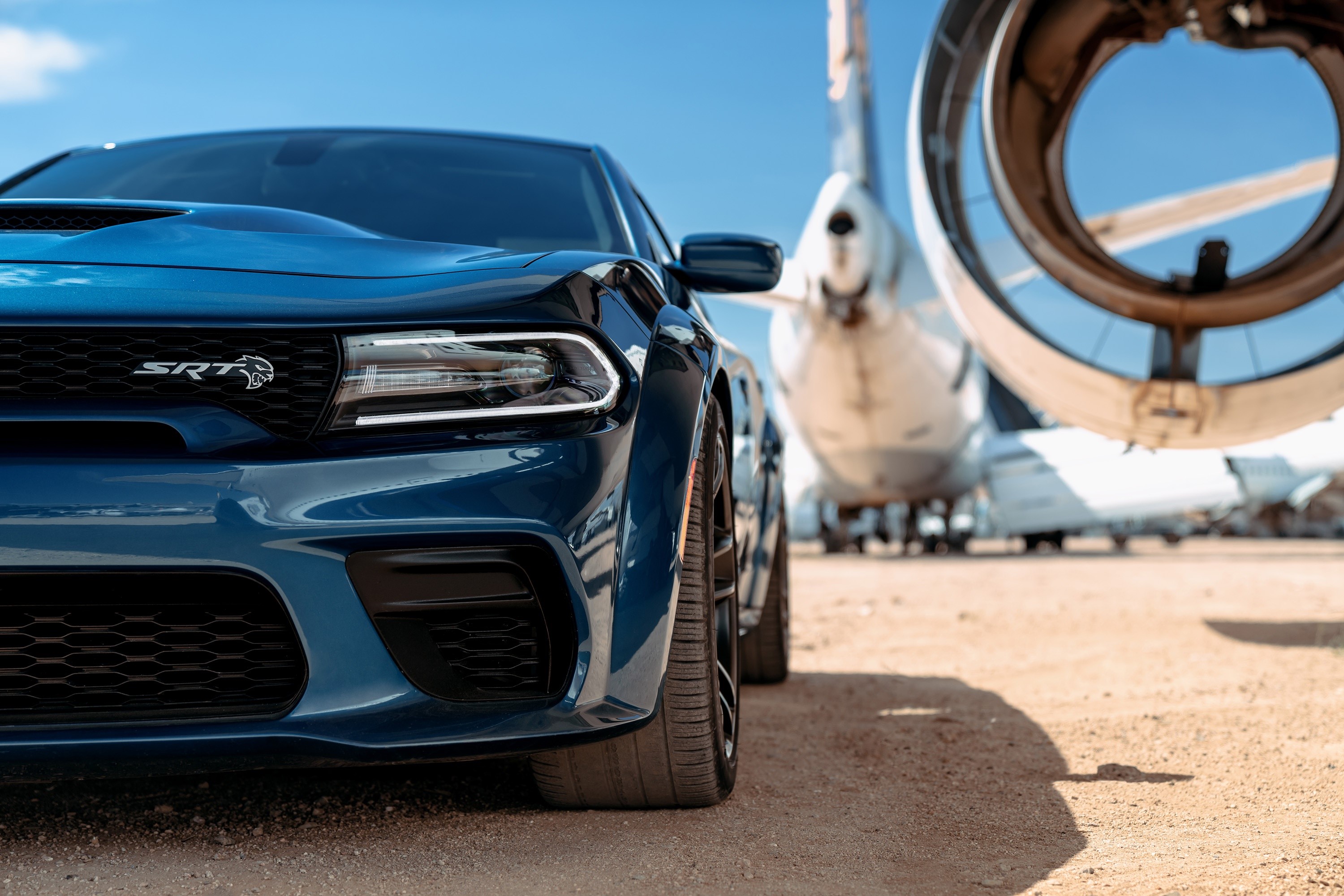 Blue Dodge SRT car parked near aircraft HD Wallpaper