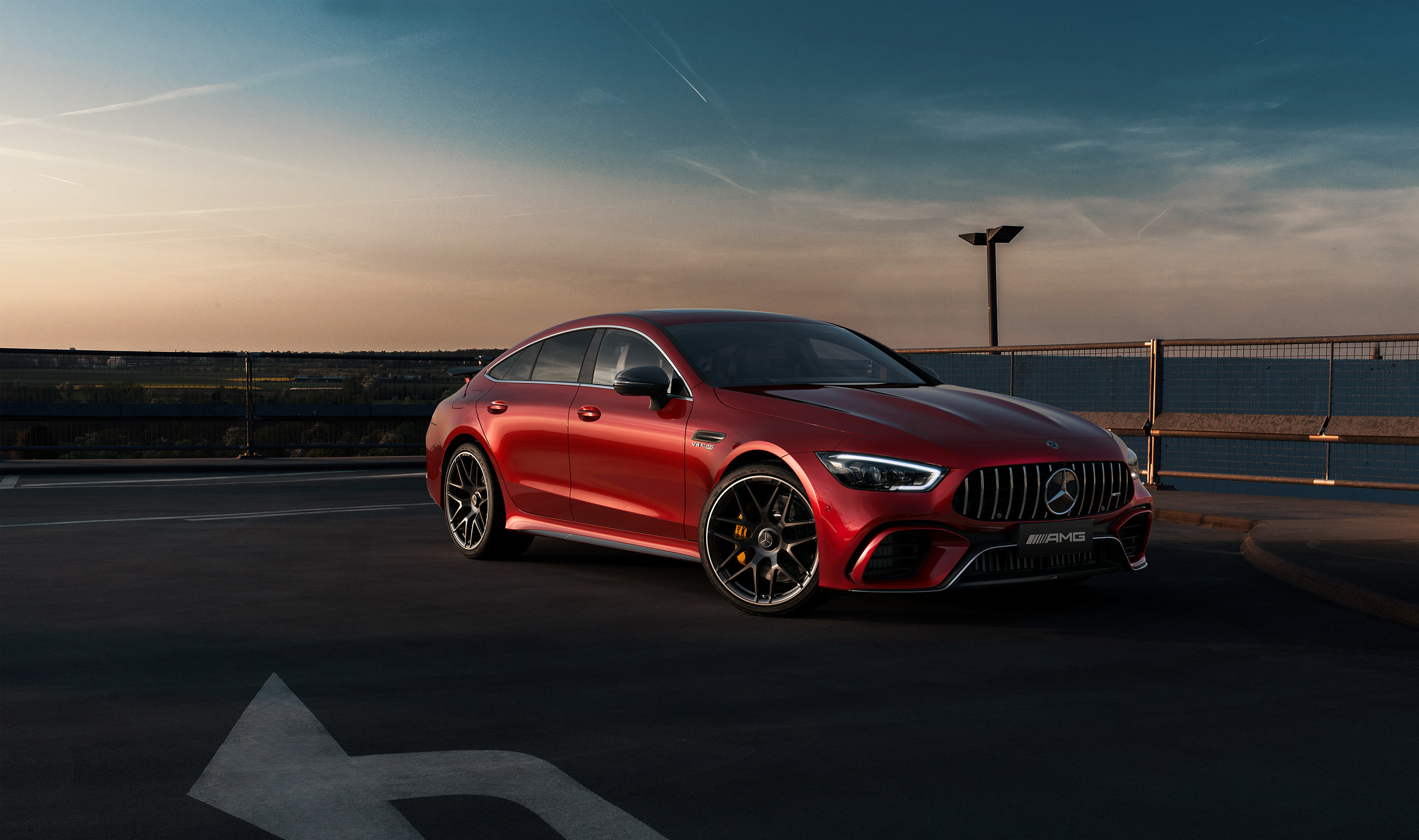 Red Mercedes-AMG GT 4-door parked on rooftop at sunset HD Wallpaper