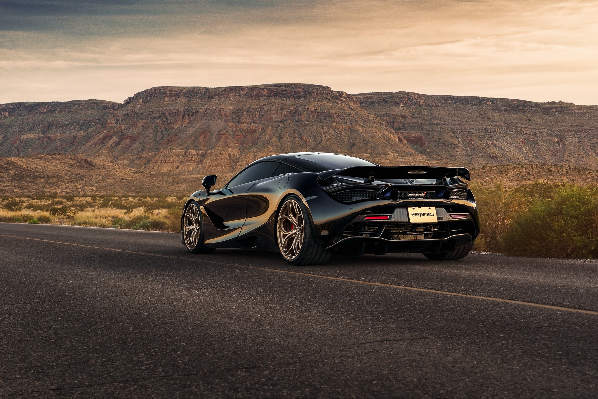 Black McLaren 720S driving on a desert road HD Wallpaper