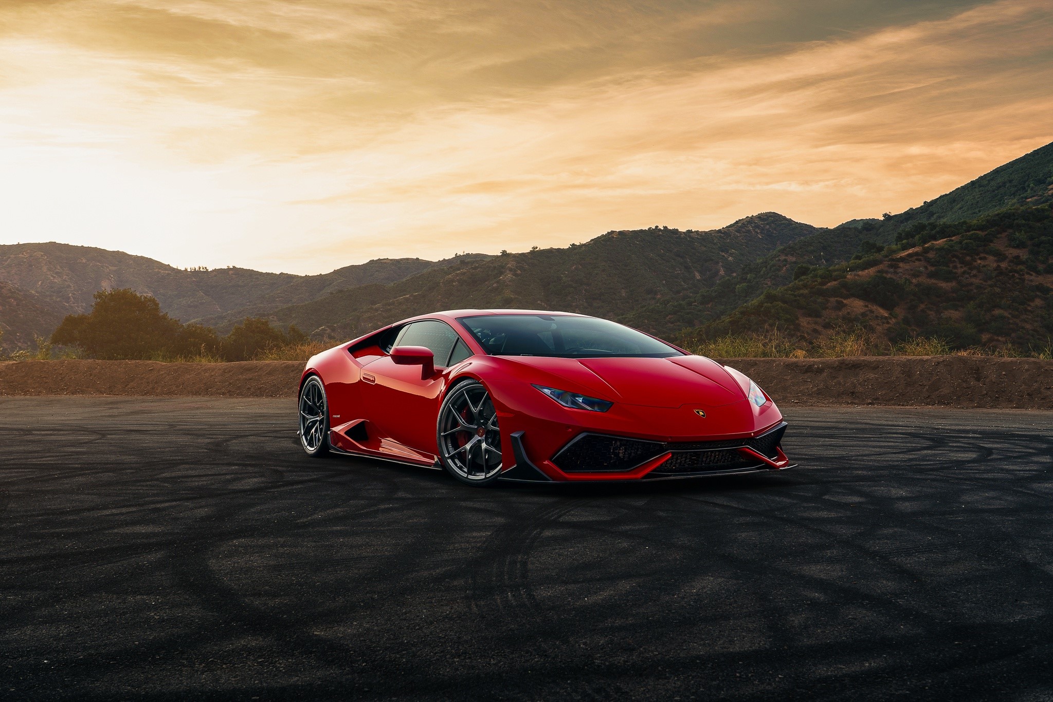Red Lamborghini Huracan on a road with mountains HD Wallpaper