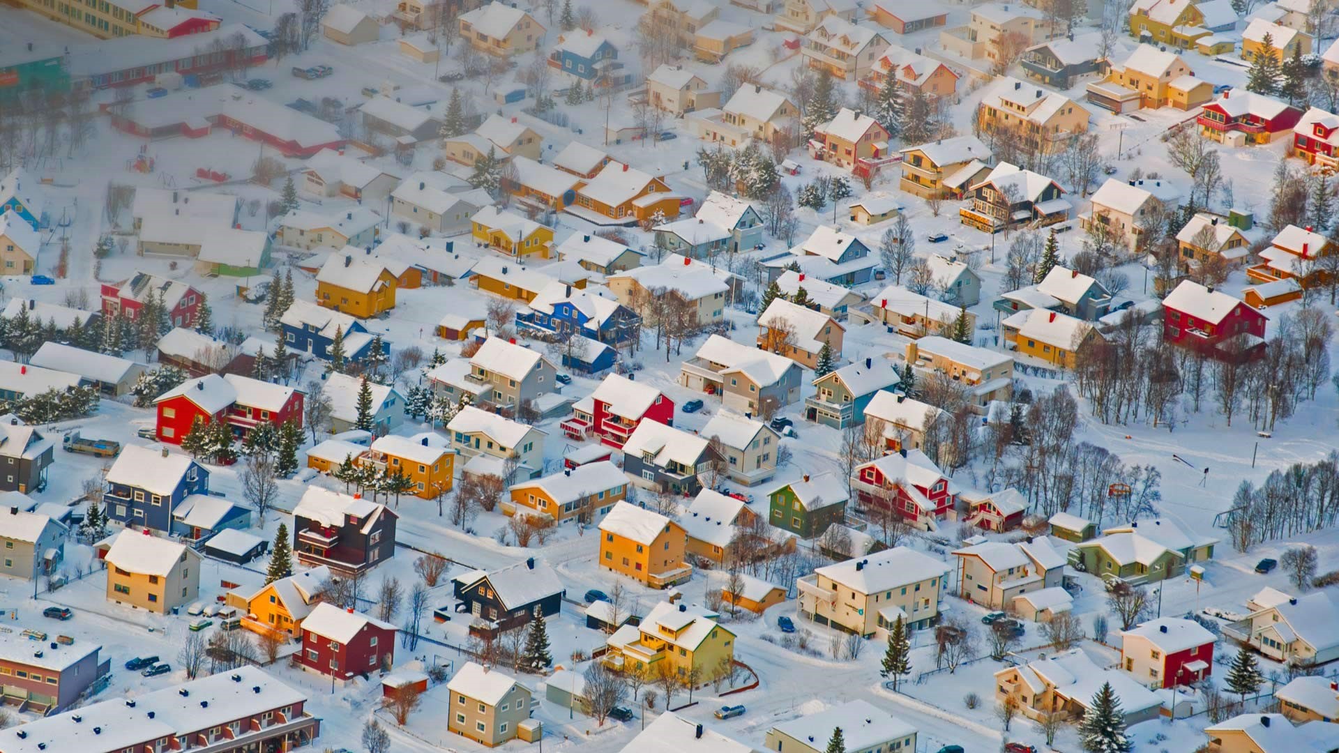 Colorful houses in a snowy landscape from an aerial view HD Wallpaper