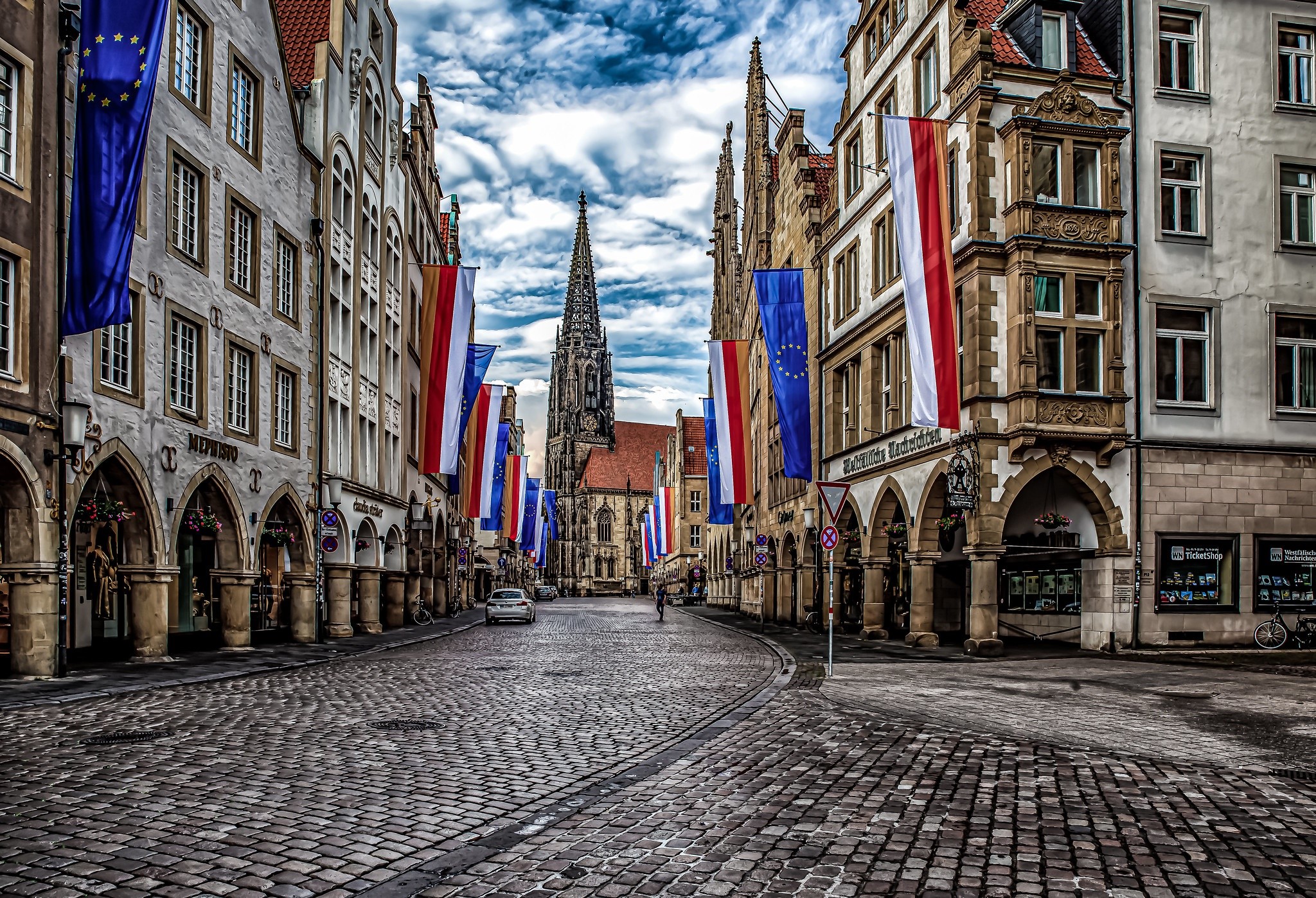 Street in Münster, Germany with flags and cathedral HD Wallpaper