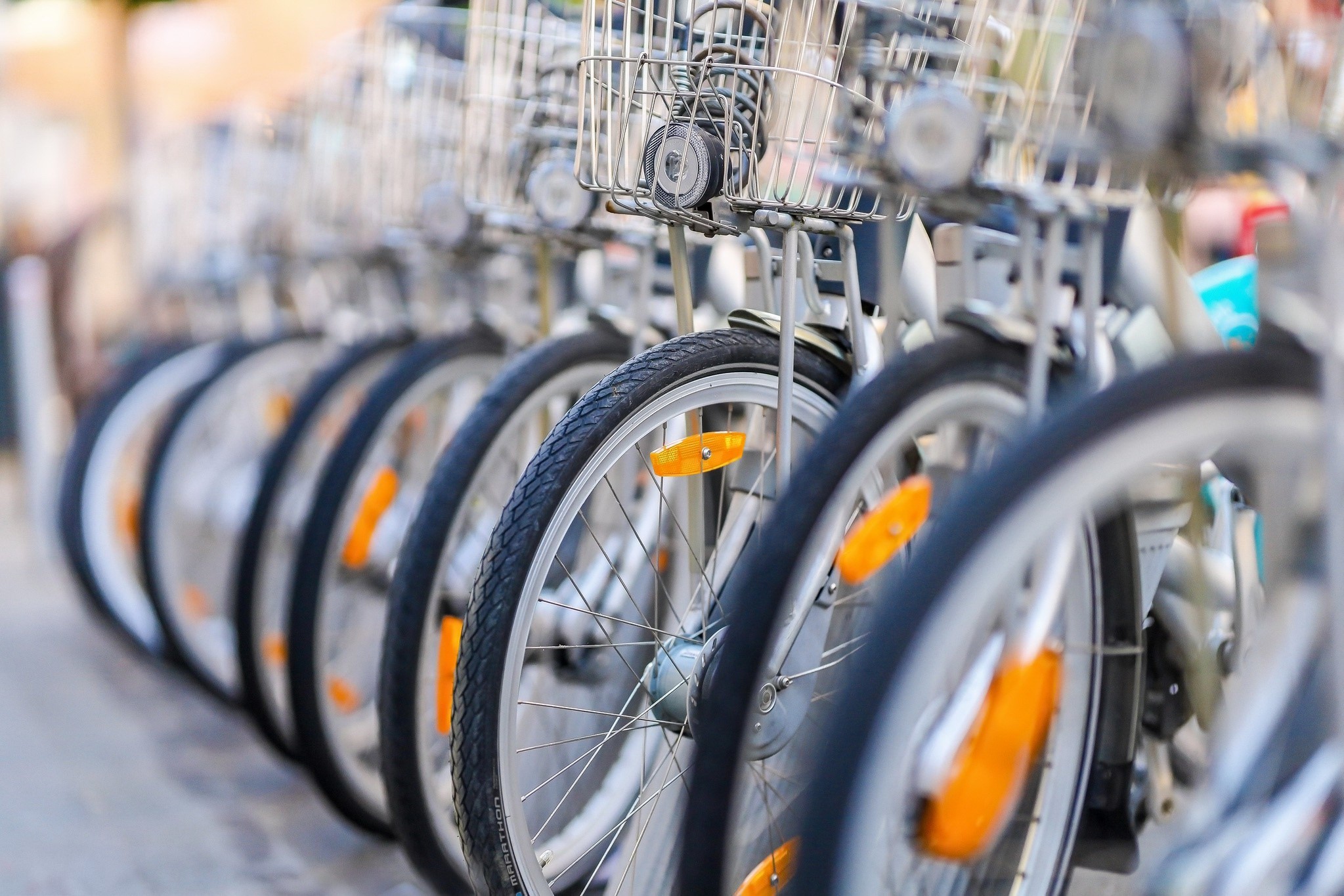 Row of rental bicycles with baskets HD Wallpaper