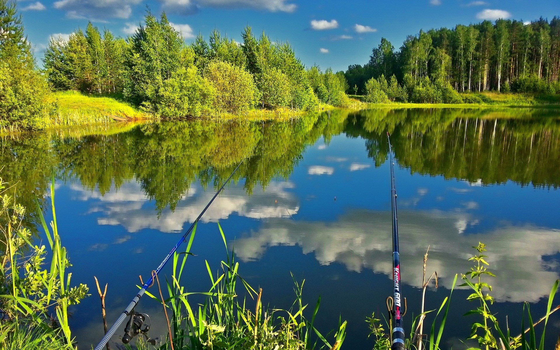 Fishing rods by a lake with reflections HD Wallpaper