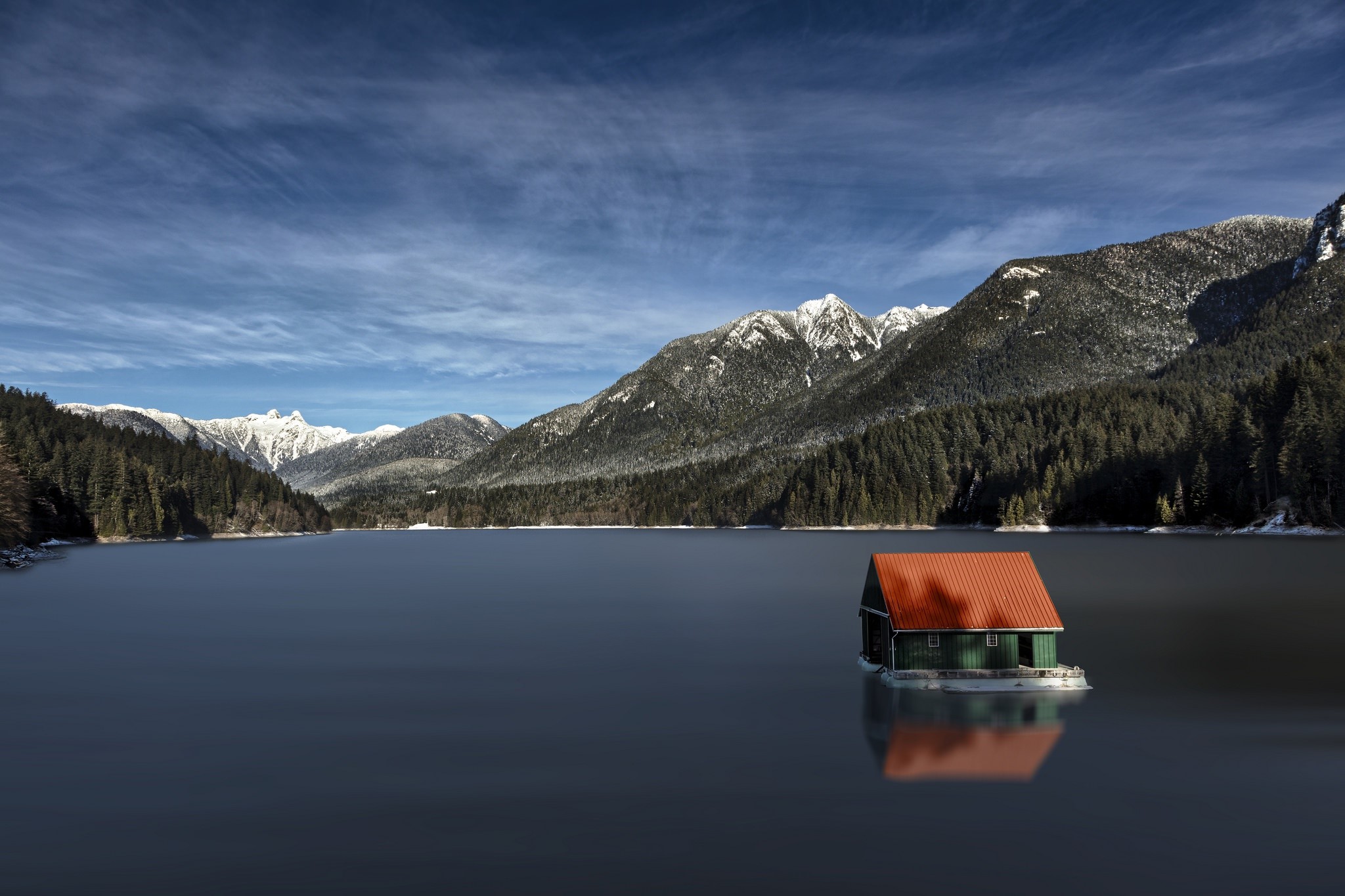 House on a lake with snow-capped mountains HD Wallpaper