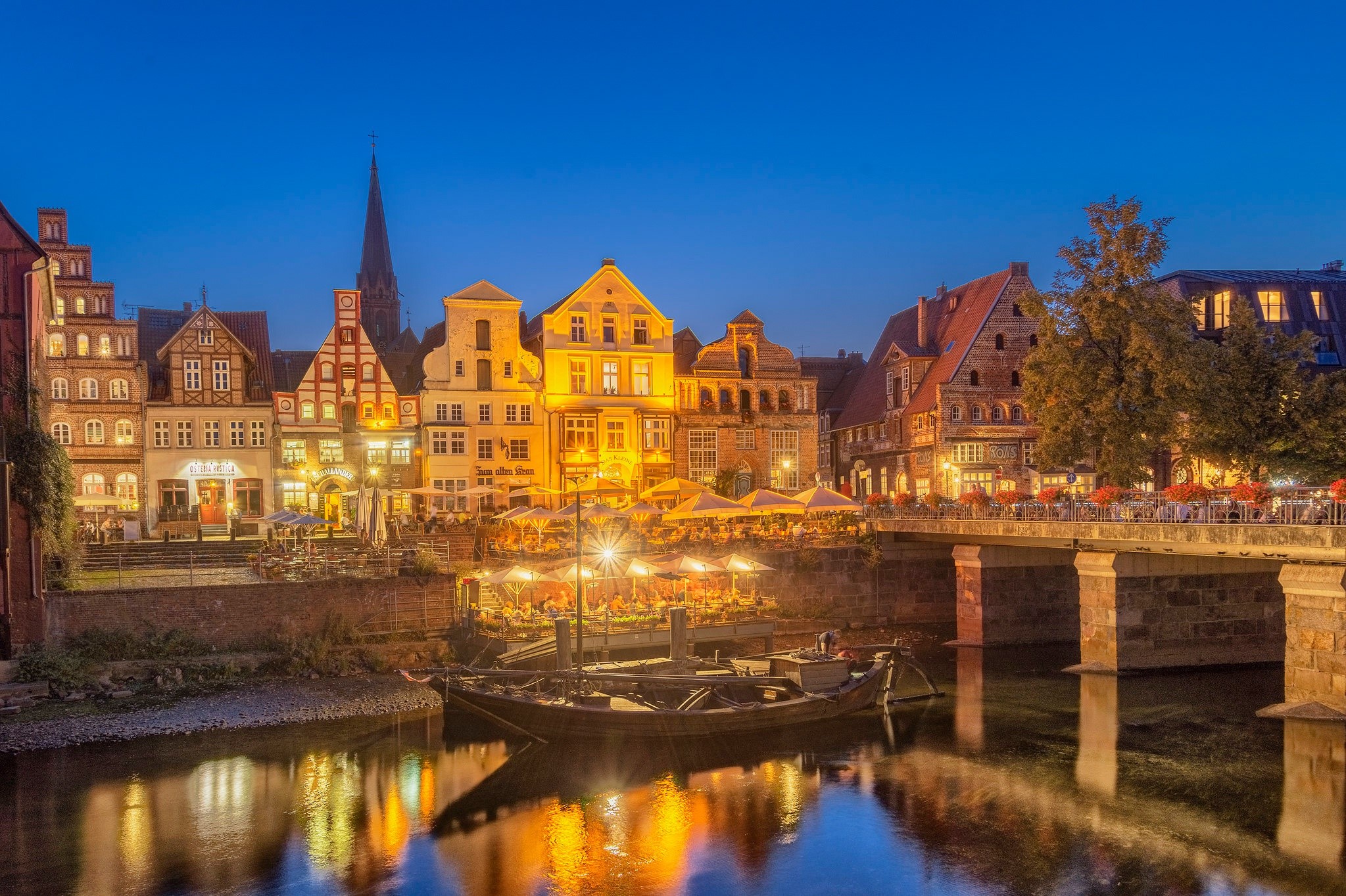 Riverfront buildings and bridge at dusk in Germany HD Wallpaper