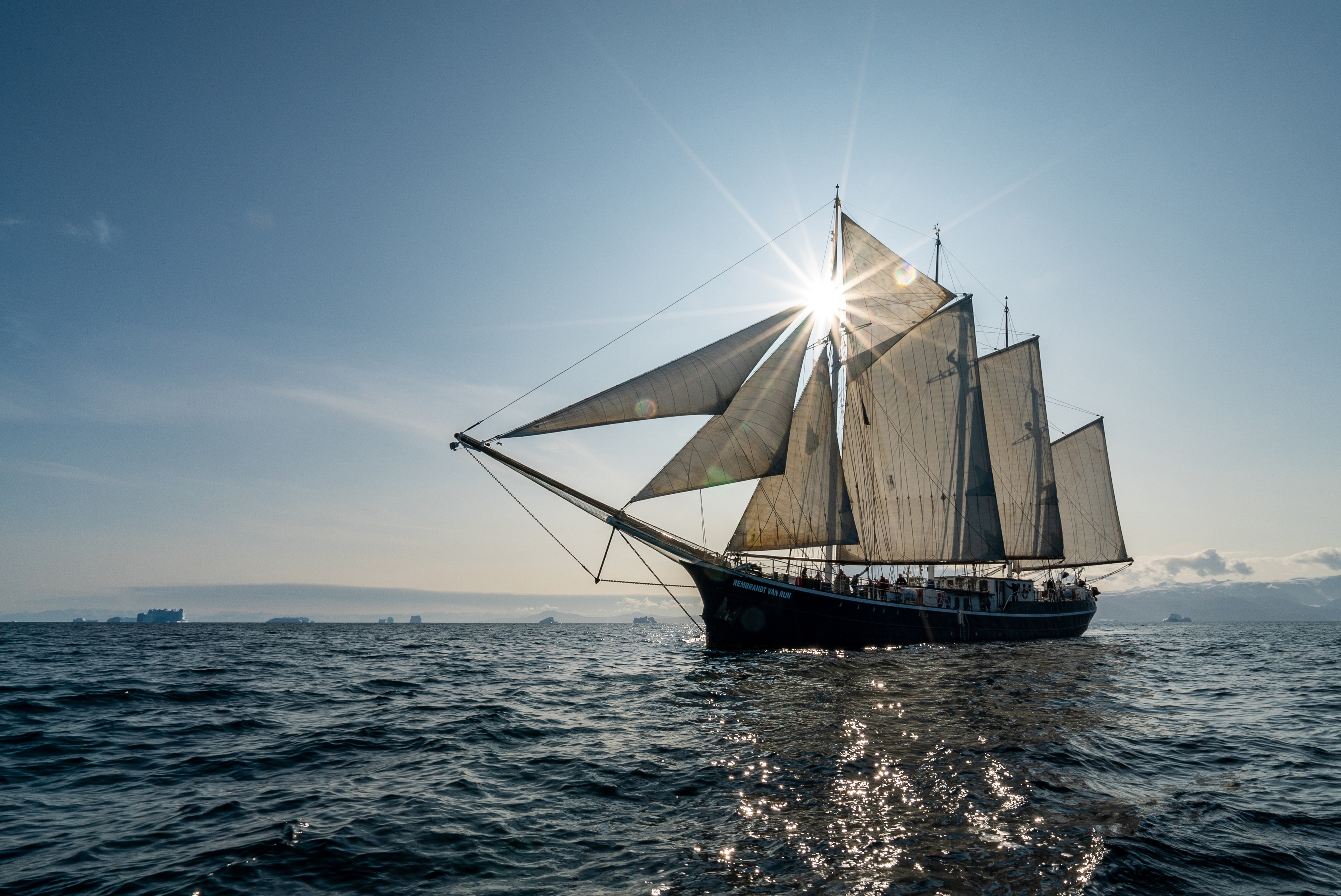 Sailing ship on the sea with sunburst HD Wallpaper