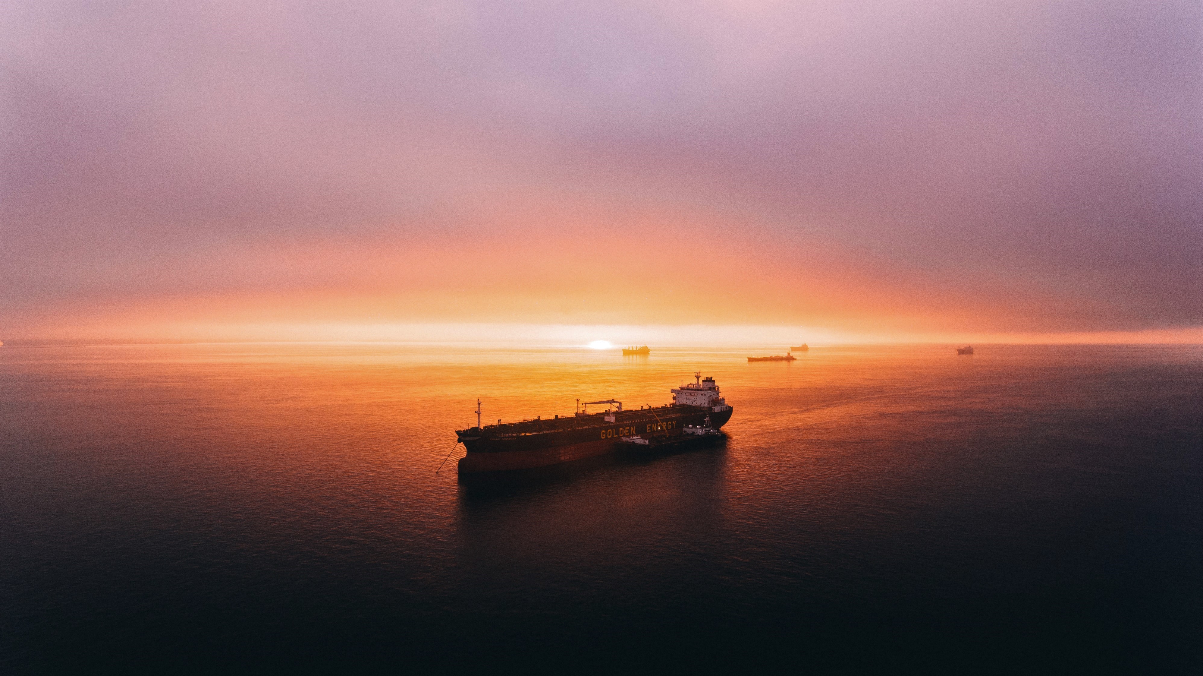 Oil tanker and tug boats at sunset in San Francisco Bay HD Wallpaper